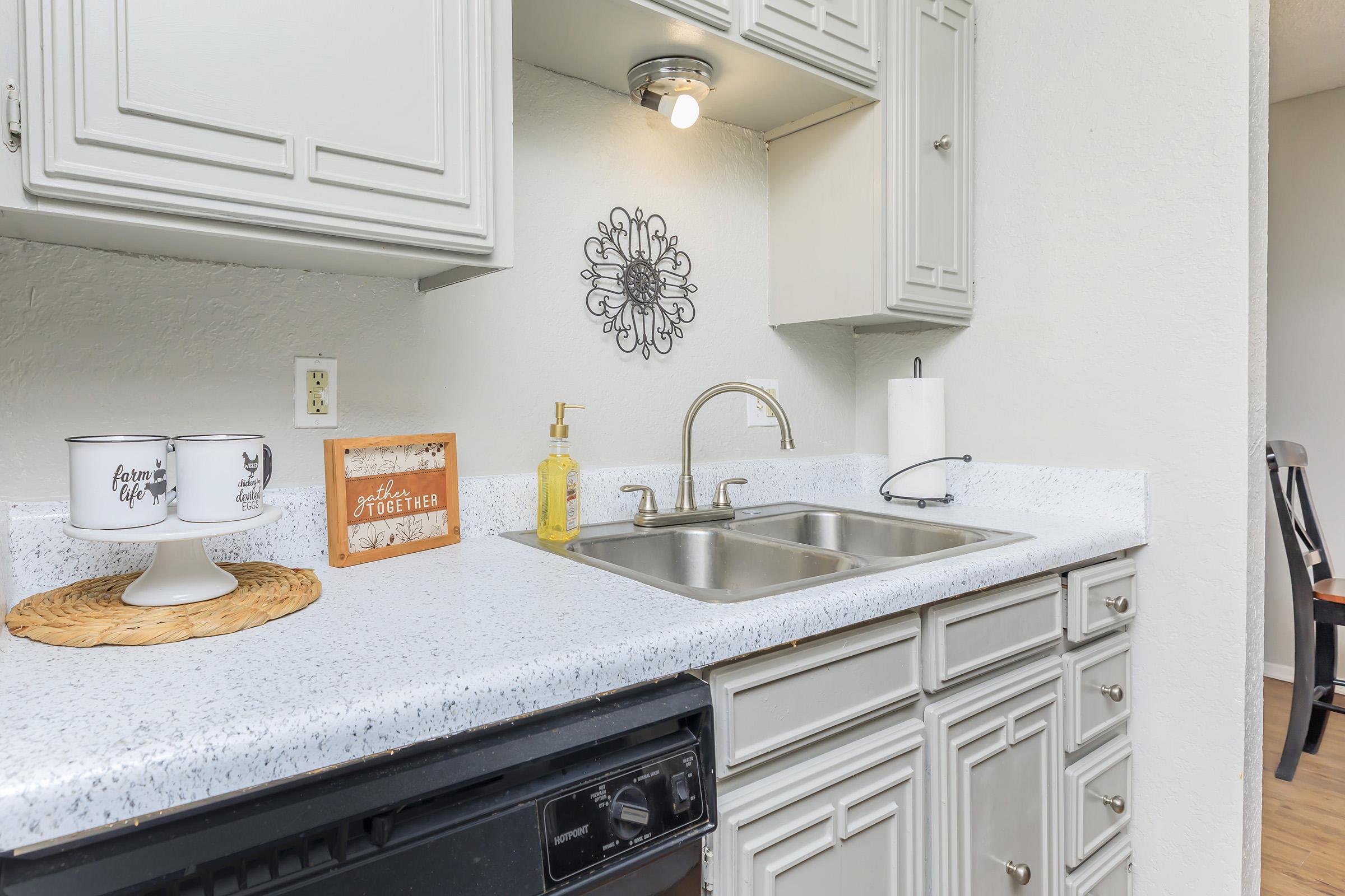 a kitchen with a sink and a mirror