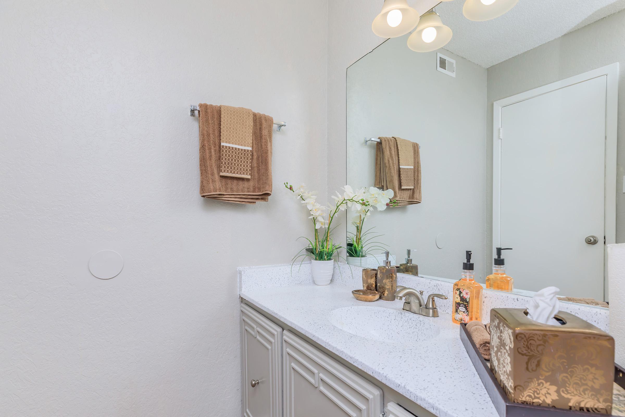 a kitchen with a sink and a mirror