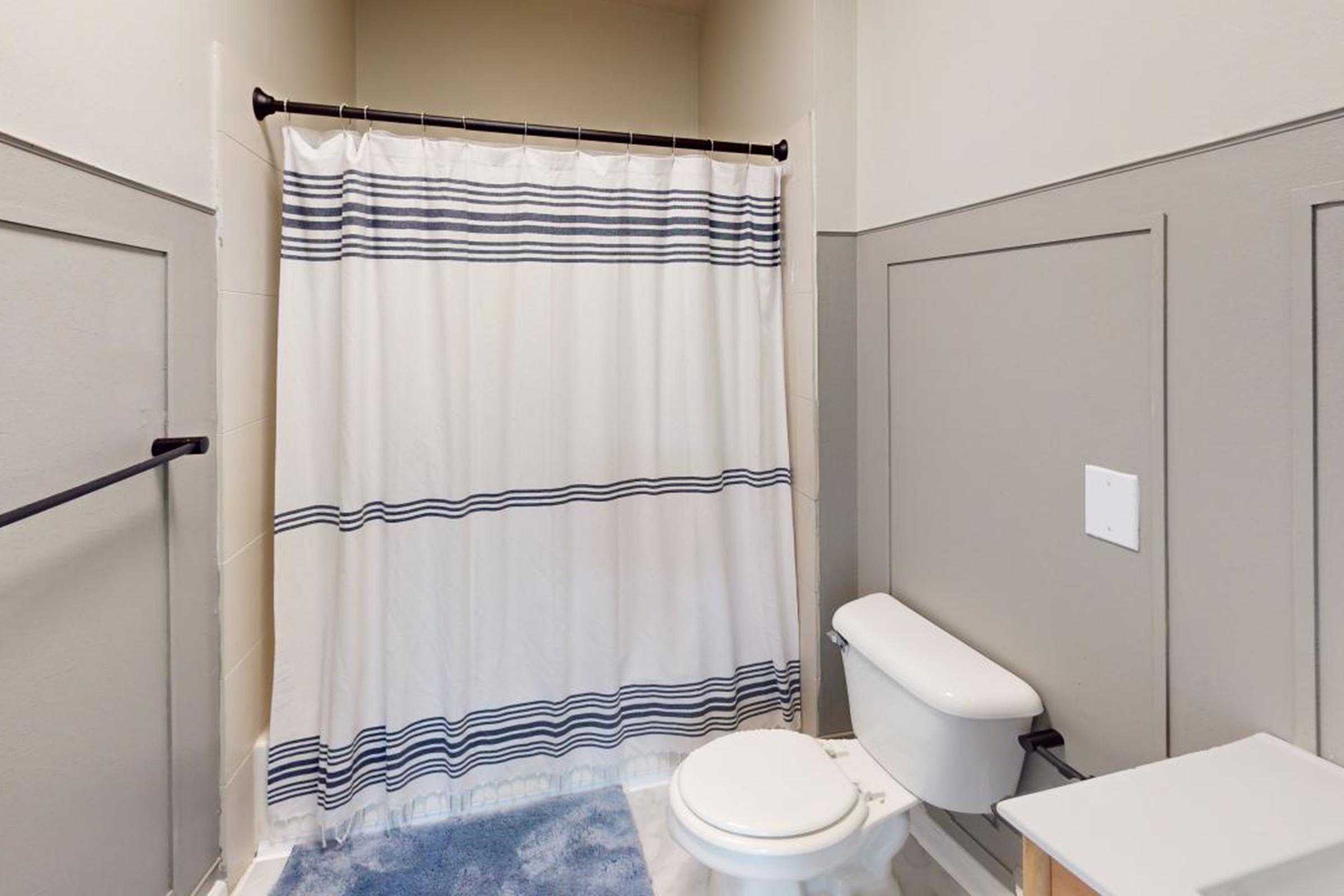 a shower curtain next to a sink