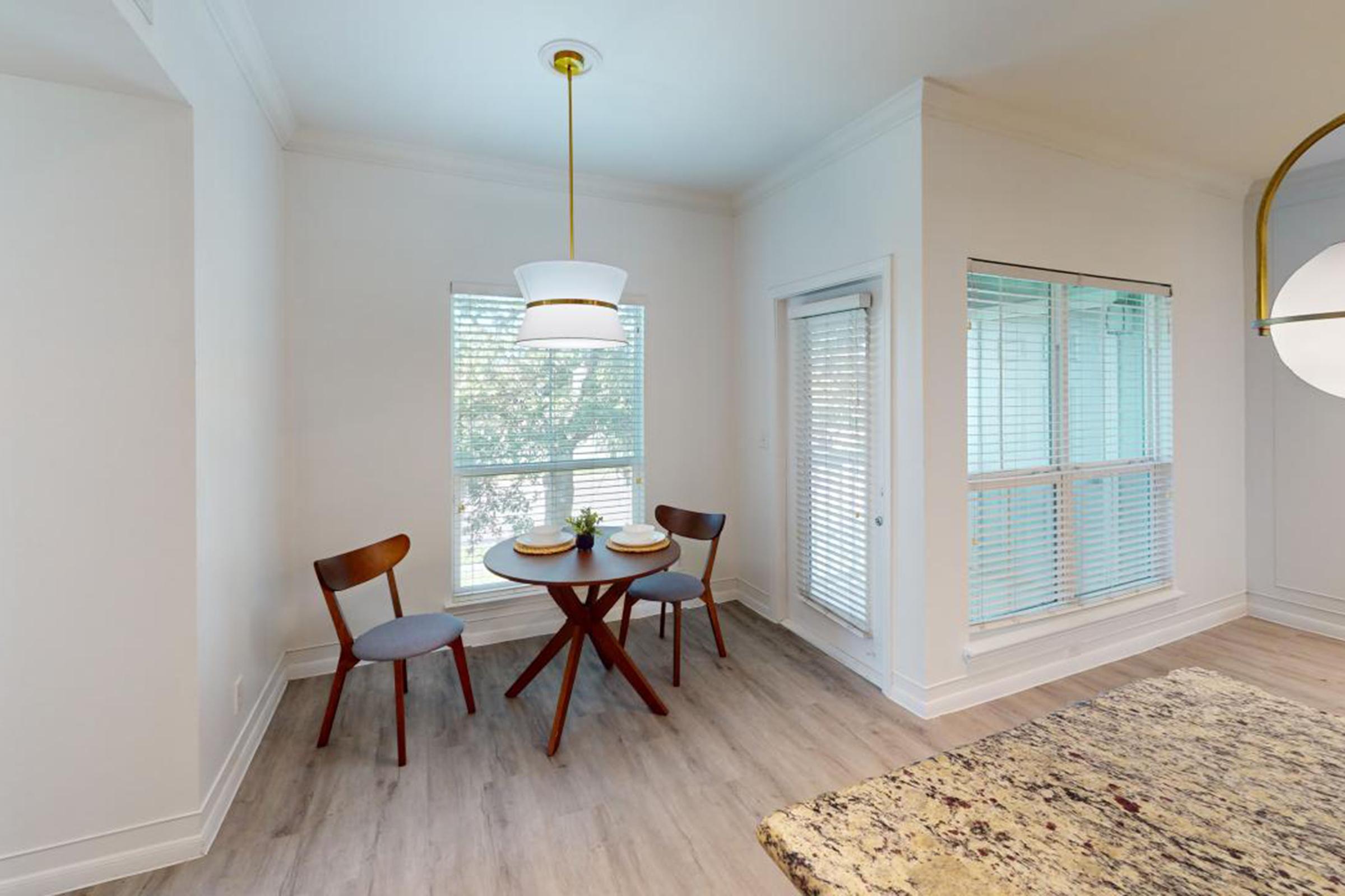 a living room filled with furniture and a large window