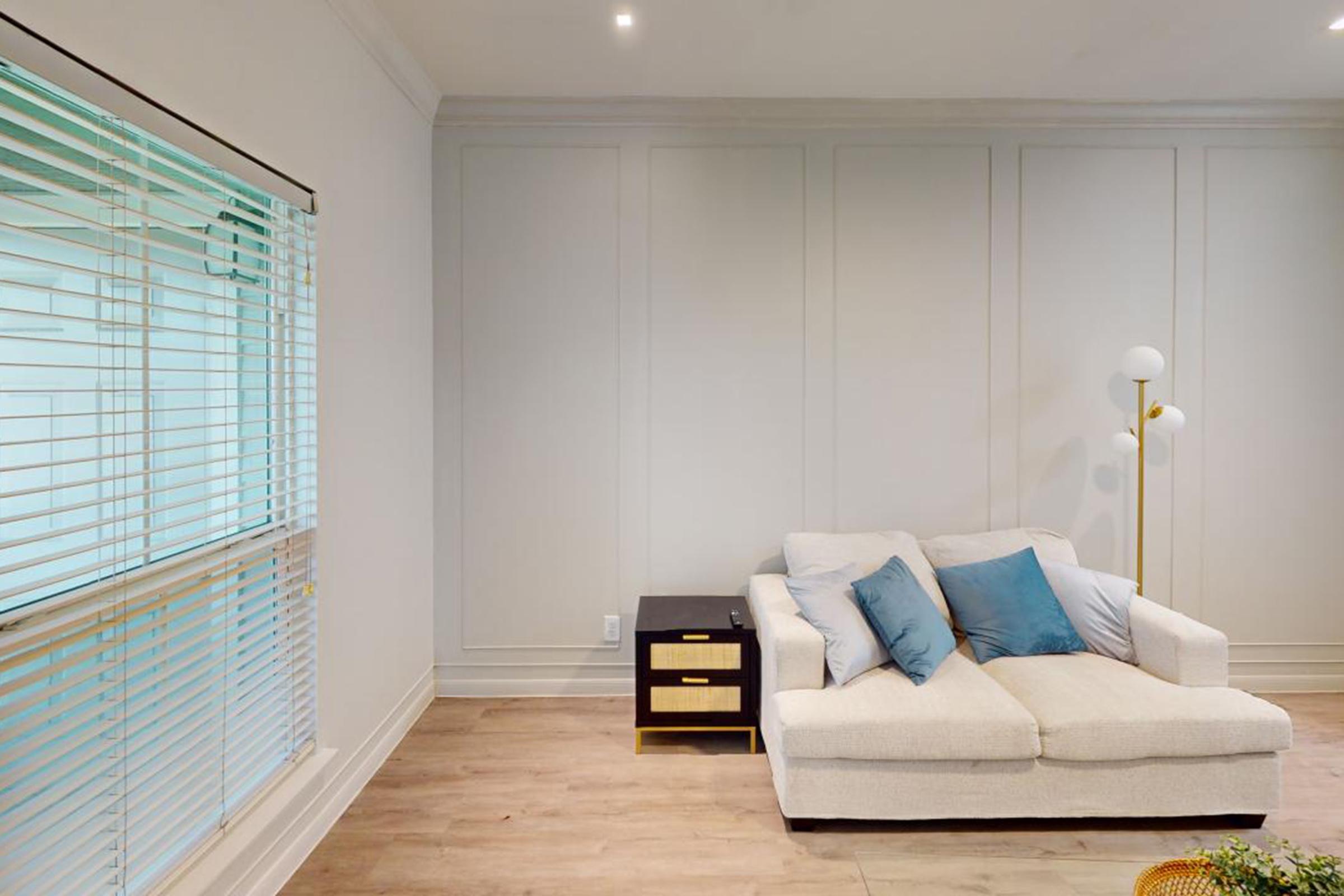 a living room filled with furniture and a large window