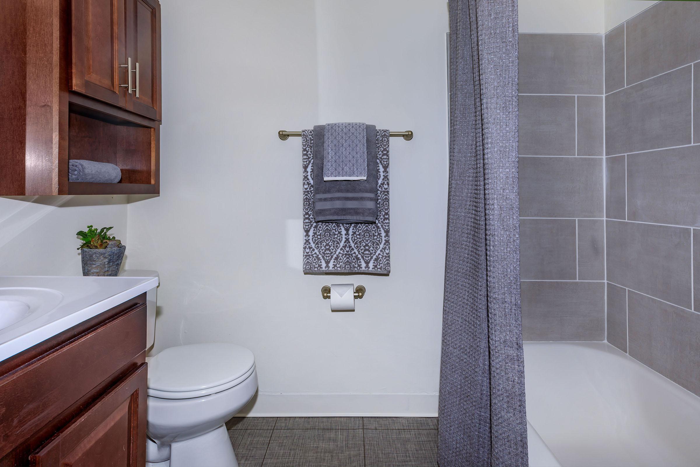 a white tub sitting next to a shower