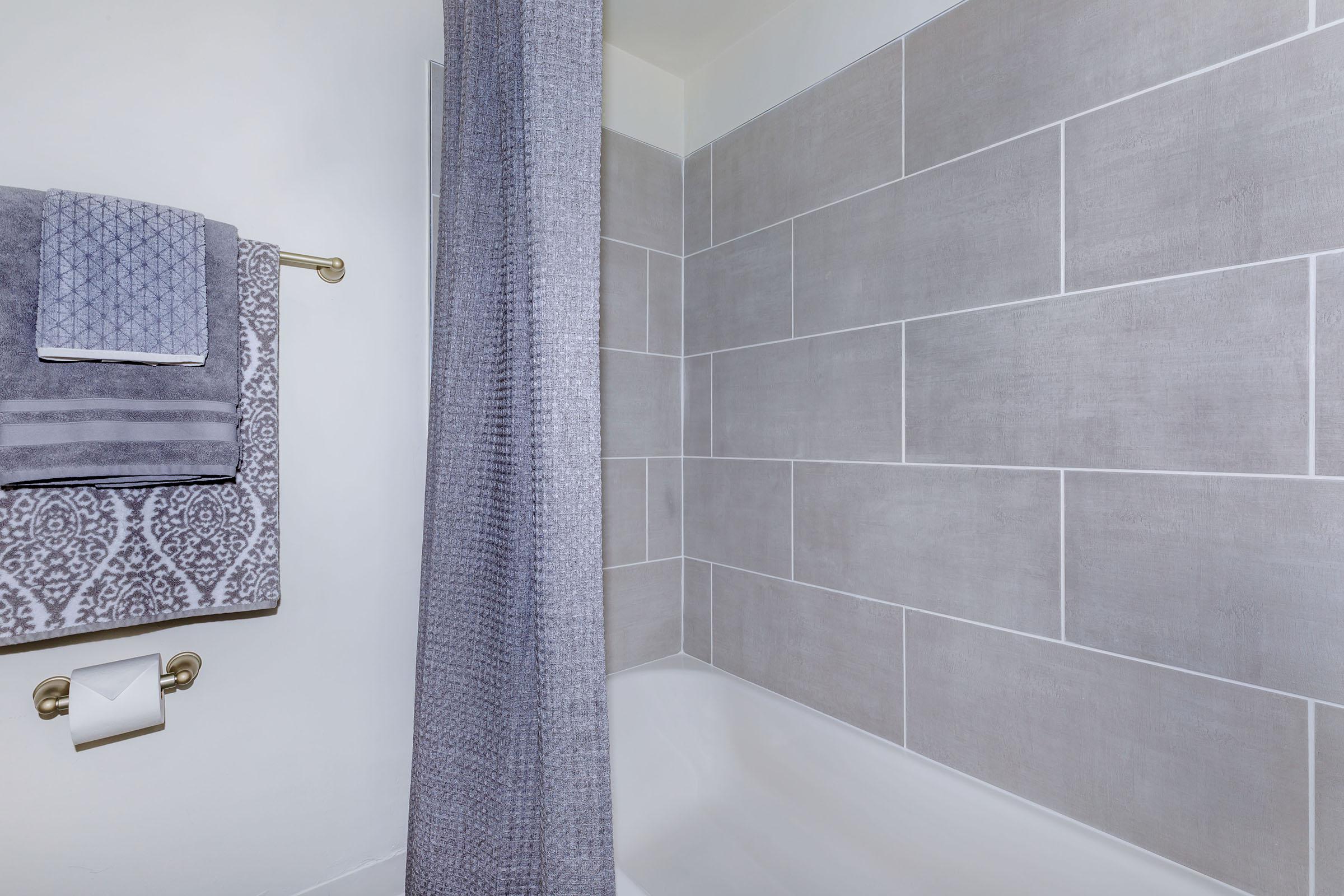 a white tub sitting next to a shower