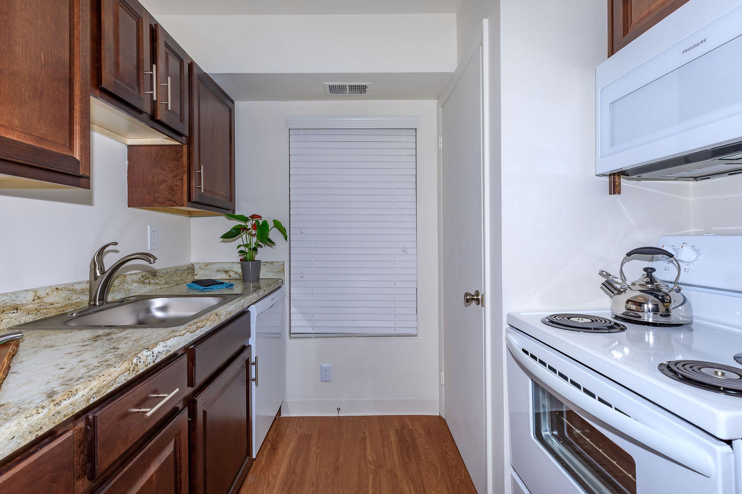 a kitchen with a stove sink and refrigerator