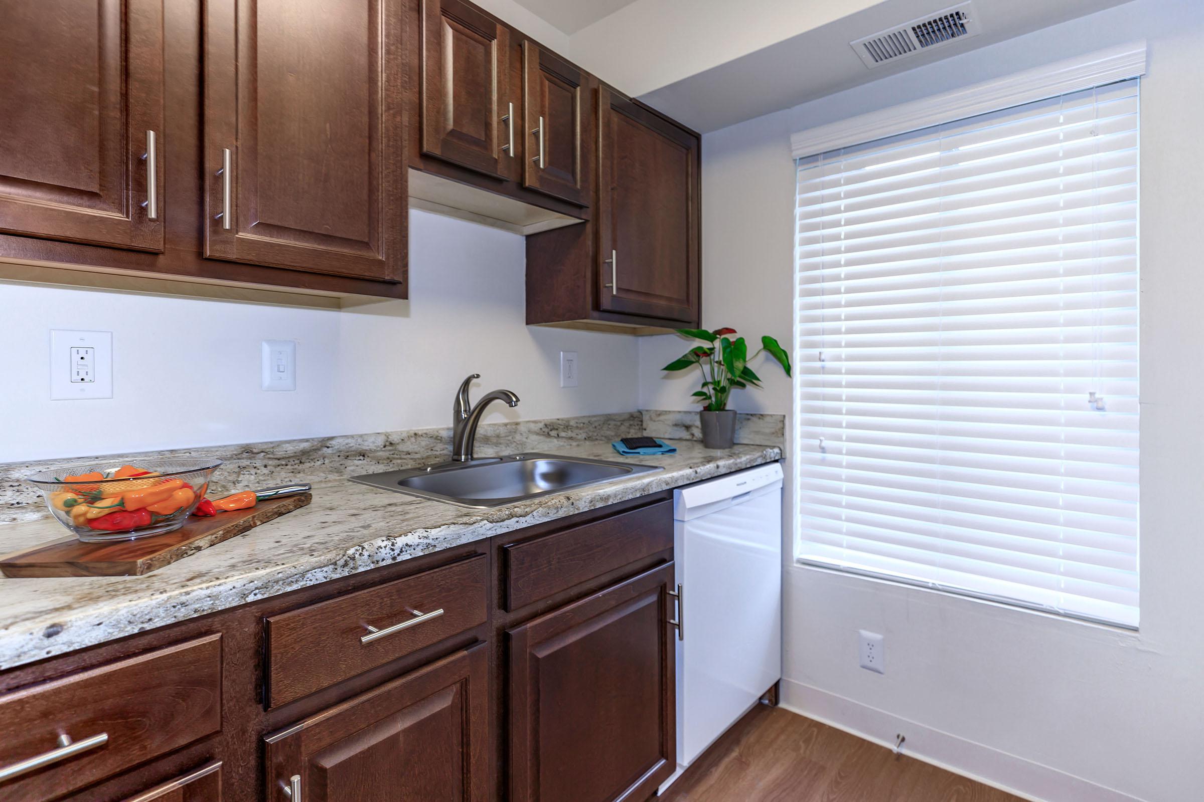 a kitchen with a stove a sink and a microwave