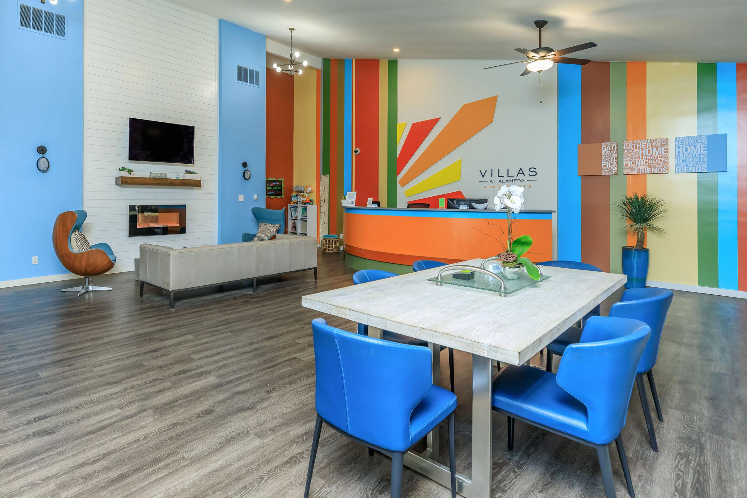 a dining room table with a blue chair