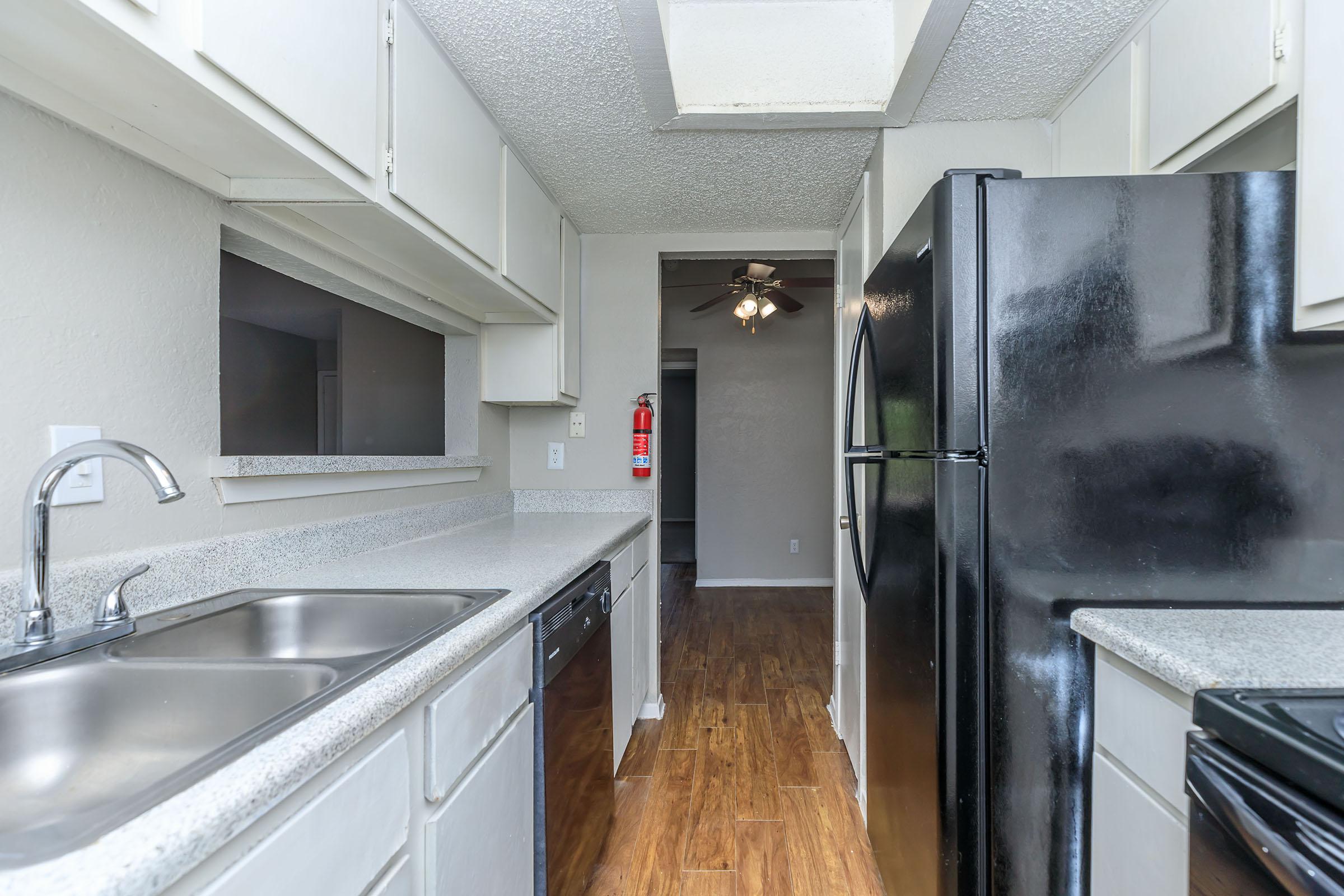 a modern kitchen with stainless steel appliances and wooden cabinets