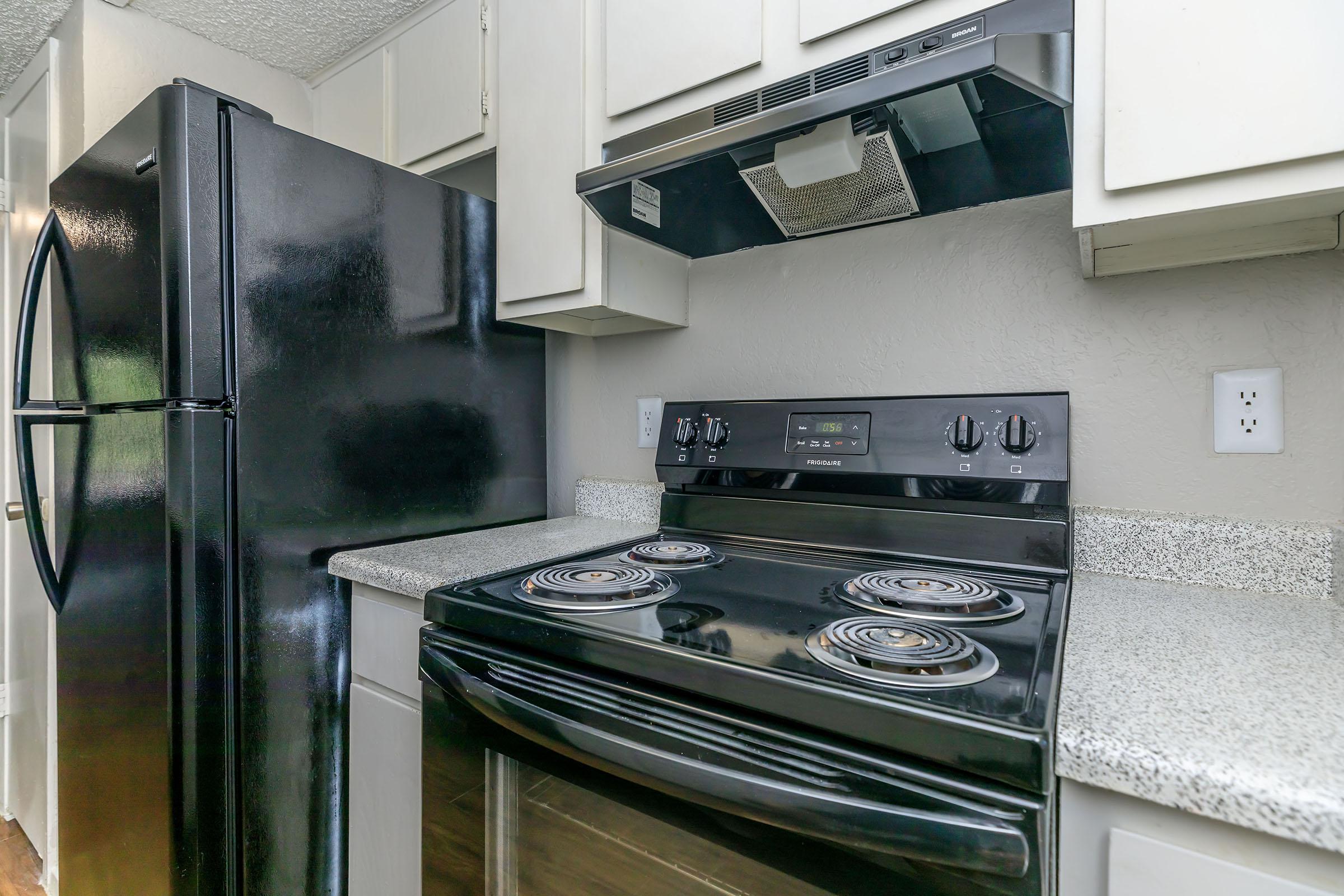 a stove top oven sitting inside of a kitchen