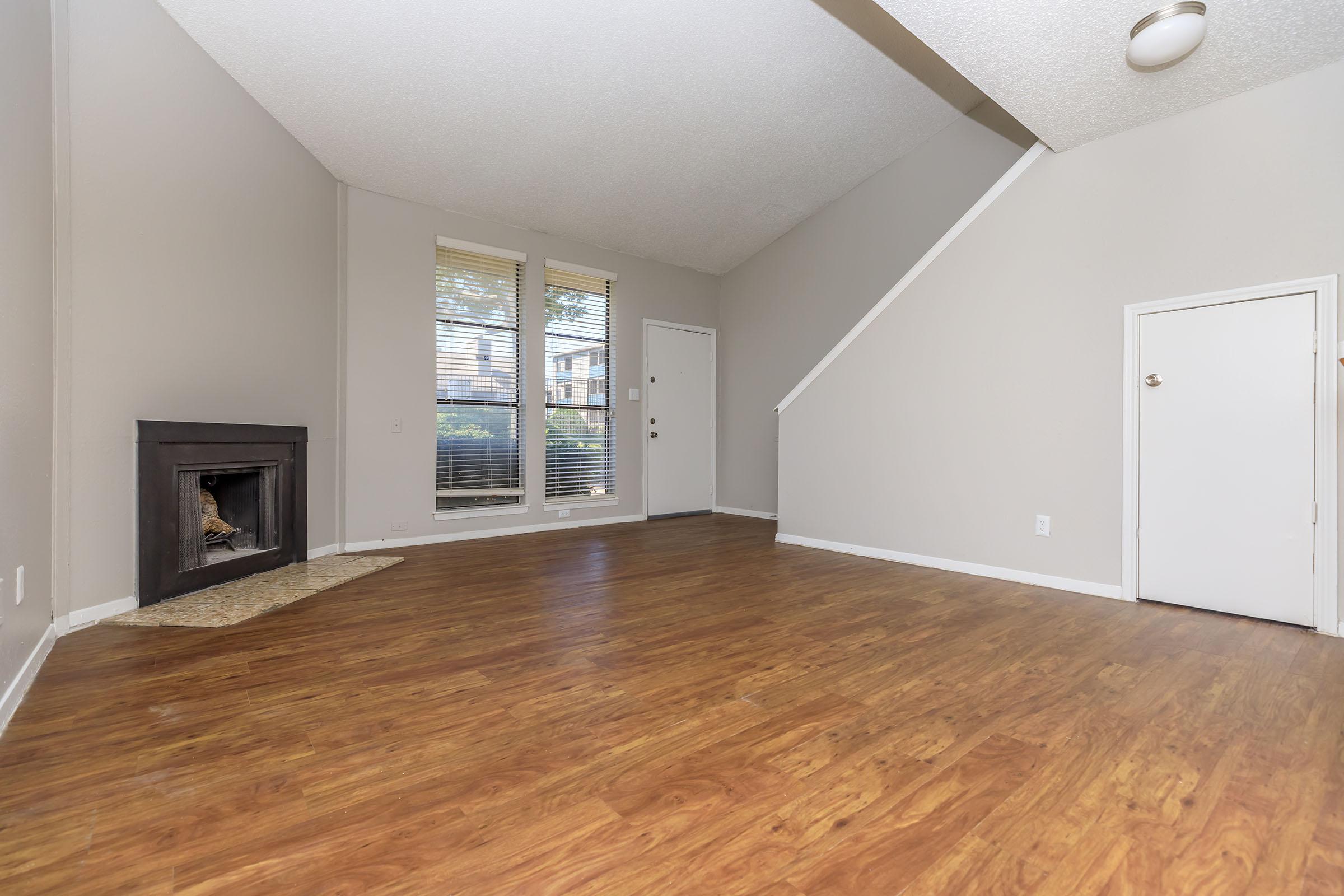 a large empty room with a wood floor