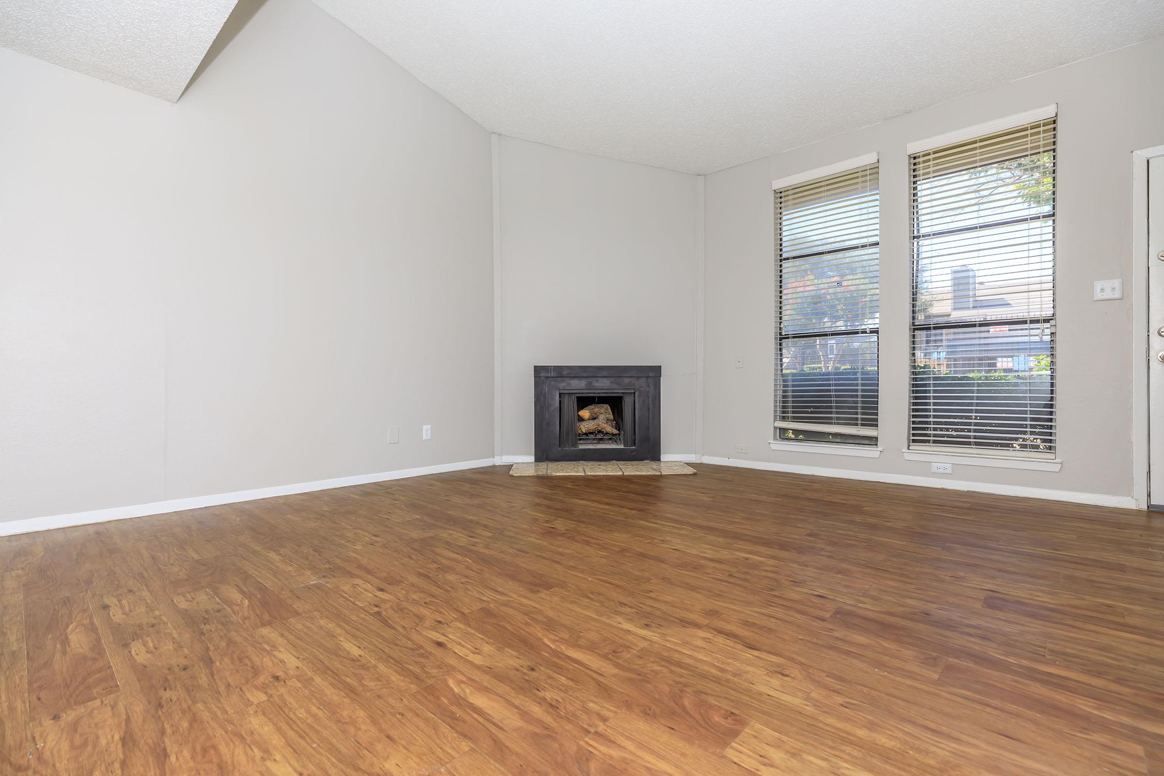 a large empty room with a wooden floor