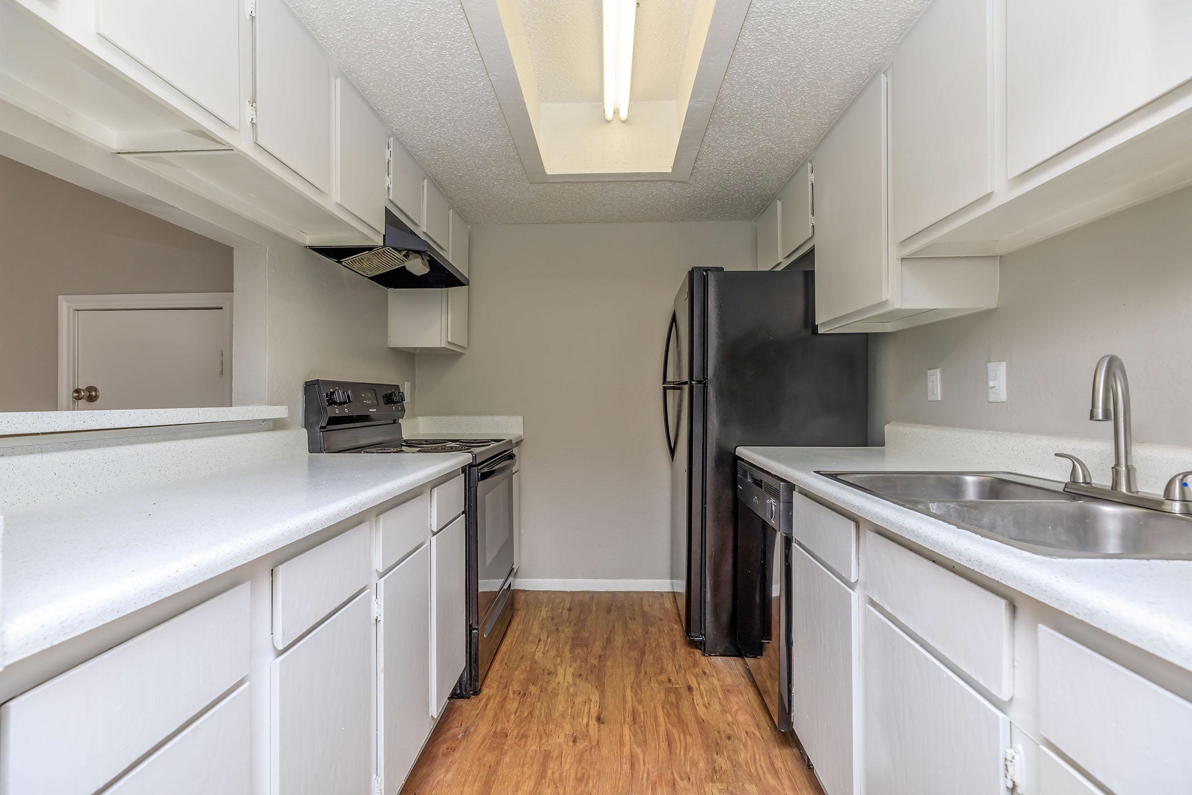 a kitchen with a sink and a mirror