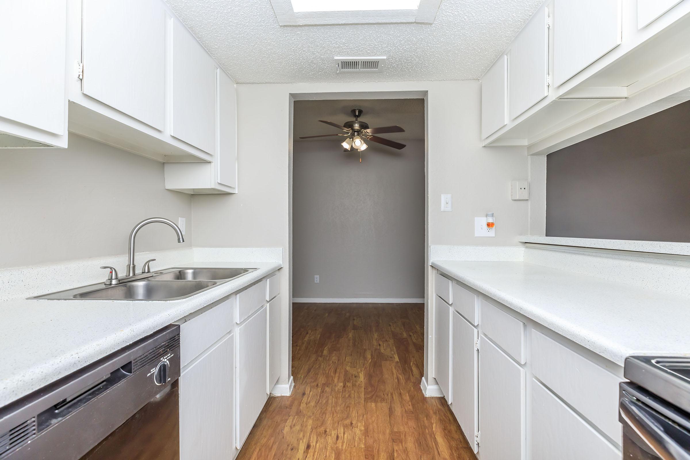 a kitchen with a sink and a mirror