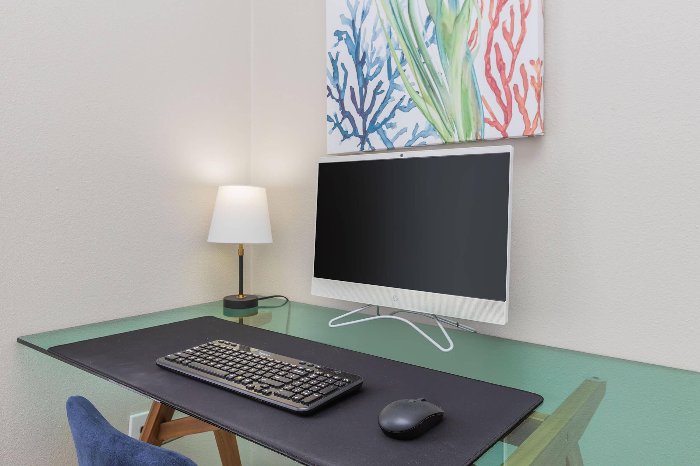 a desk with a computer on a table