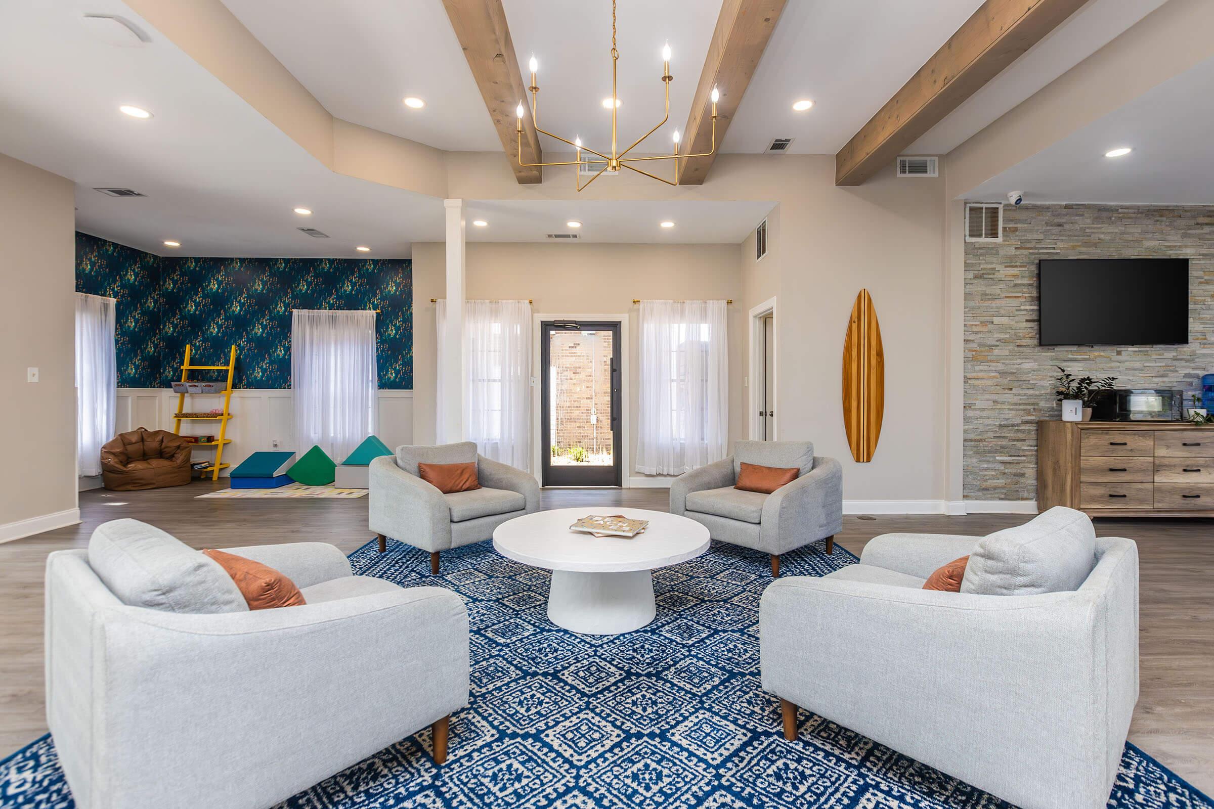 a living room filled with furniture and a flat screen tv