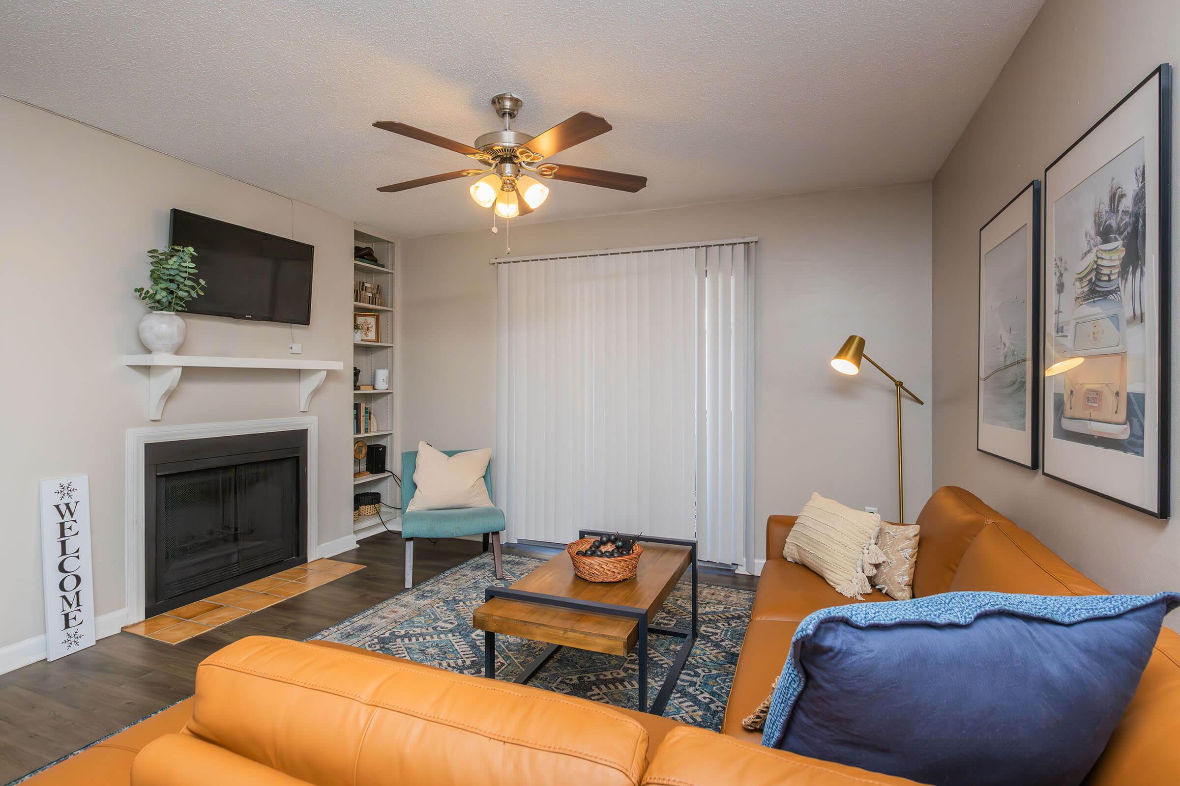 a living room filled with furniture and a flat screen tv