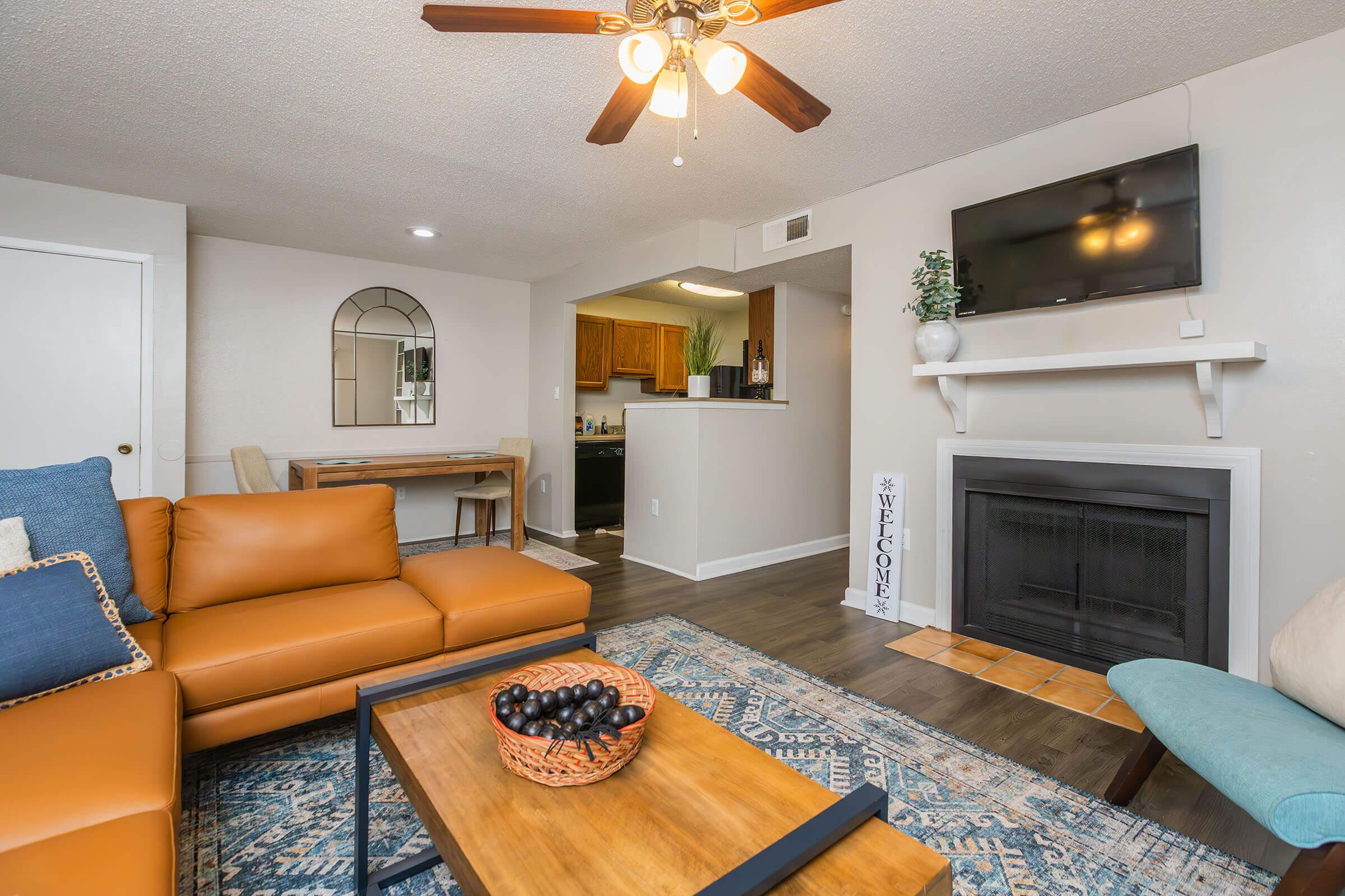 a living room filled with furniture and a flat screen tv