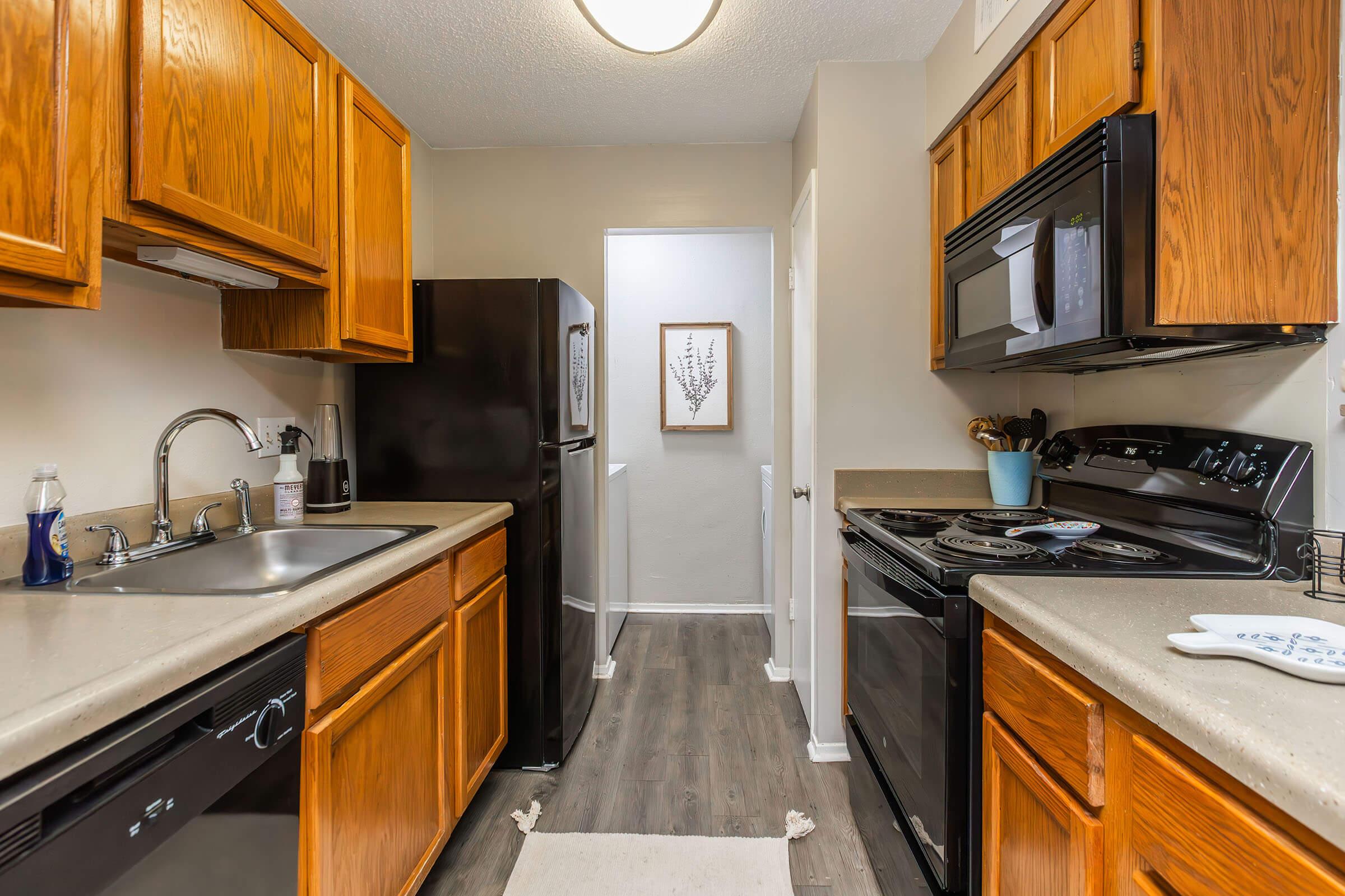 a kitchen with a stove a sink and a microwave