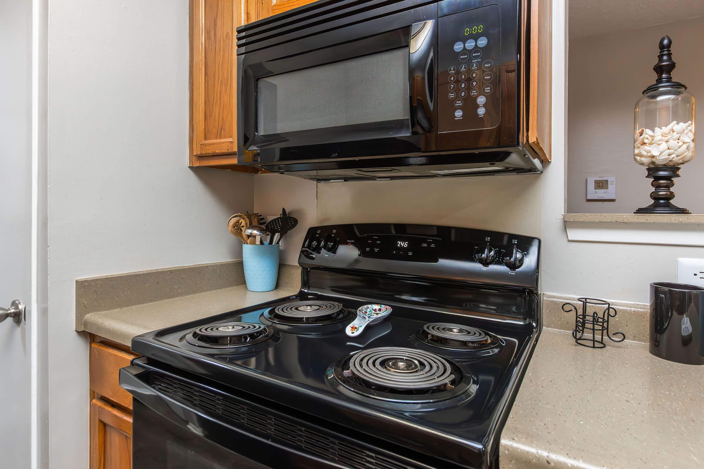 a stove top oven sitting inside of a kitchen