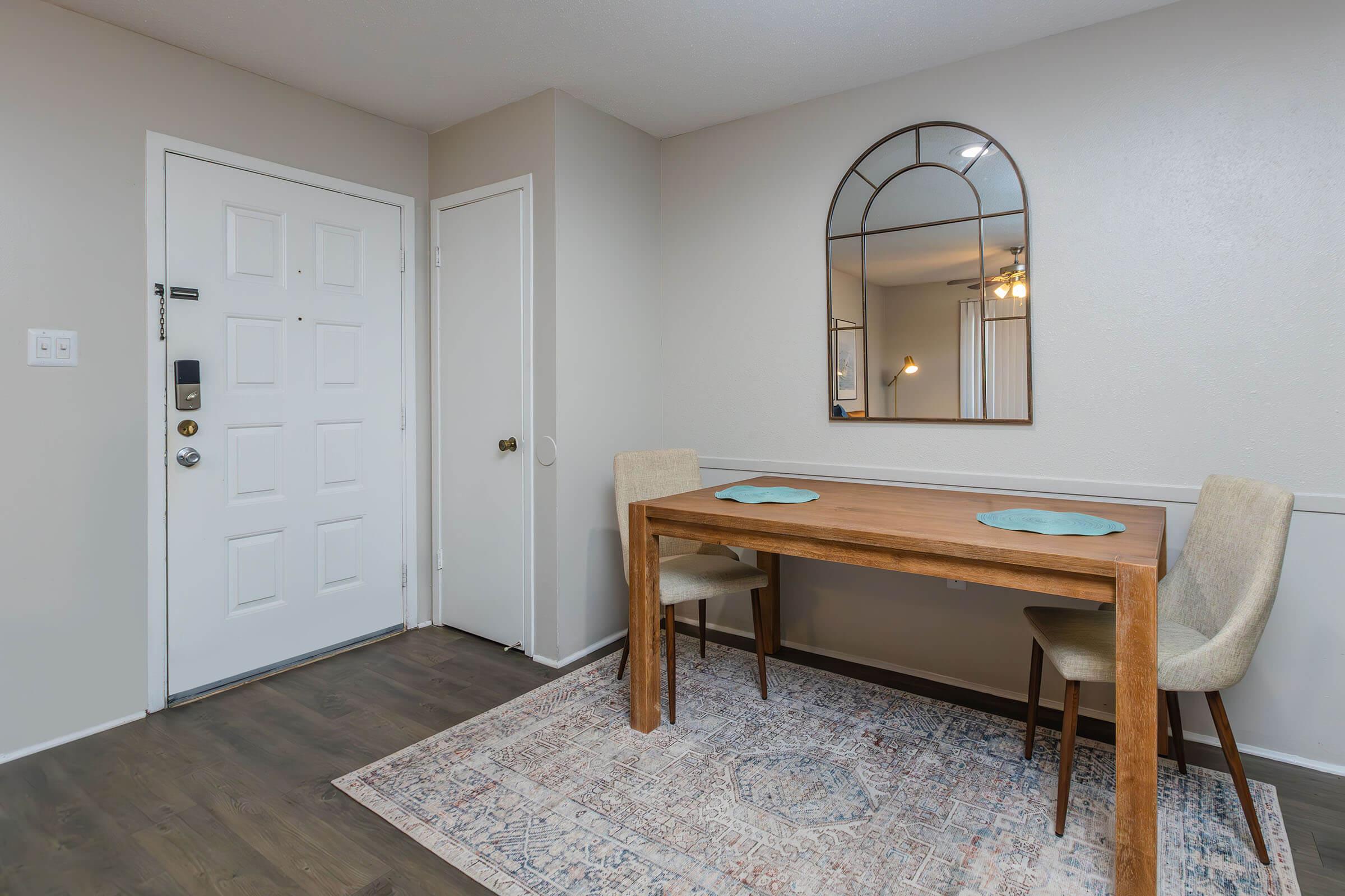 a bedroom with a bed and desk in a room