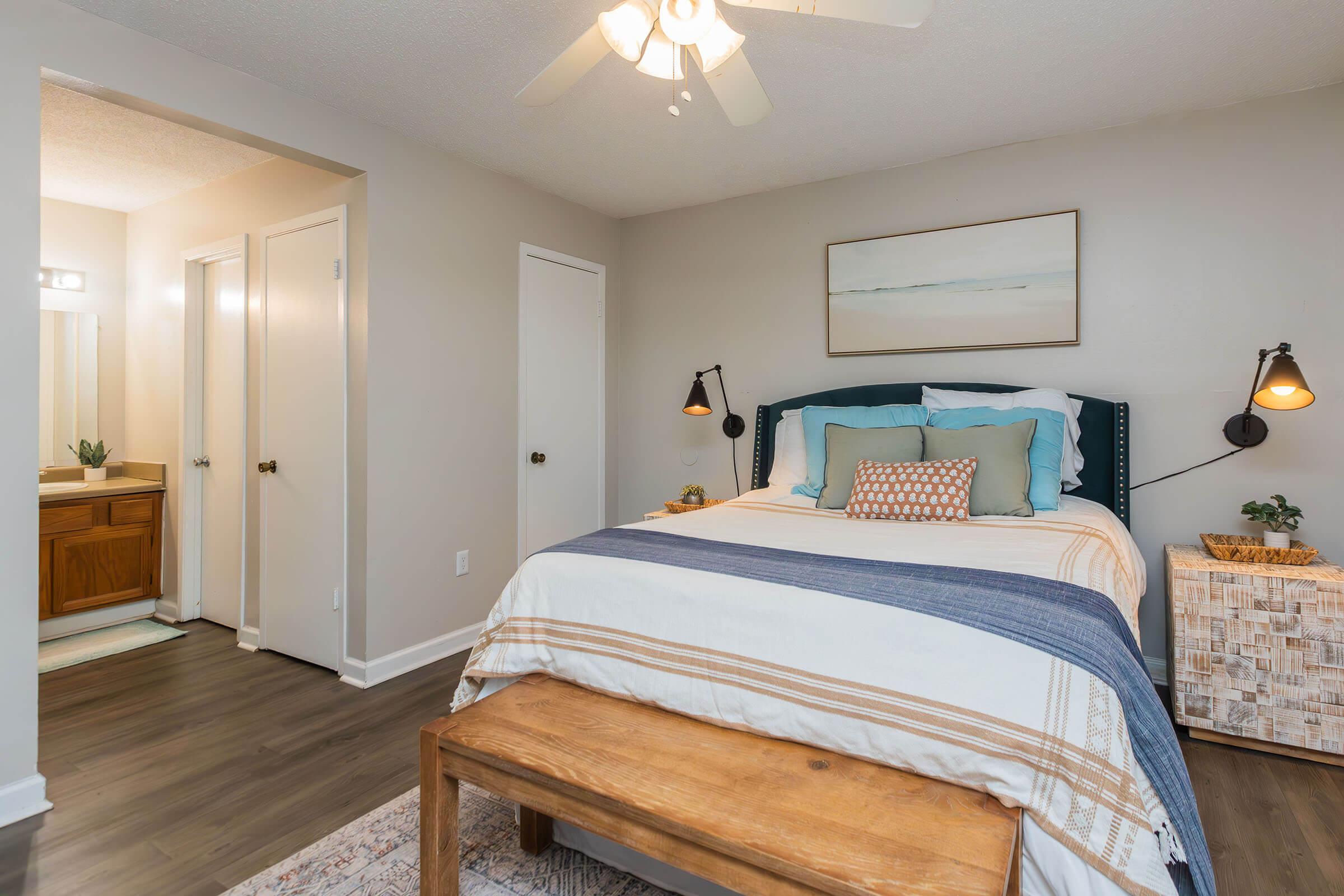 a bedroom with a bed and desk in a room