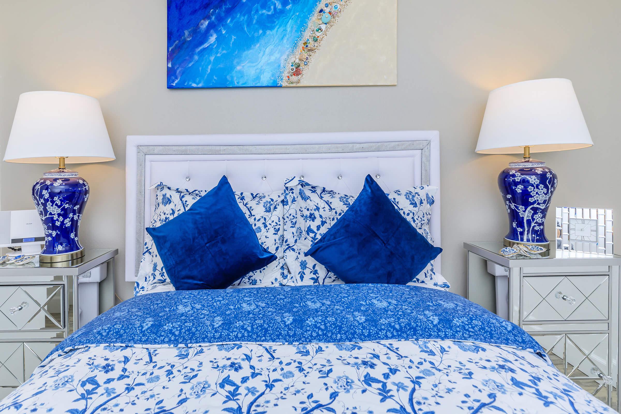 a bedroom with a bed and a blue blanket