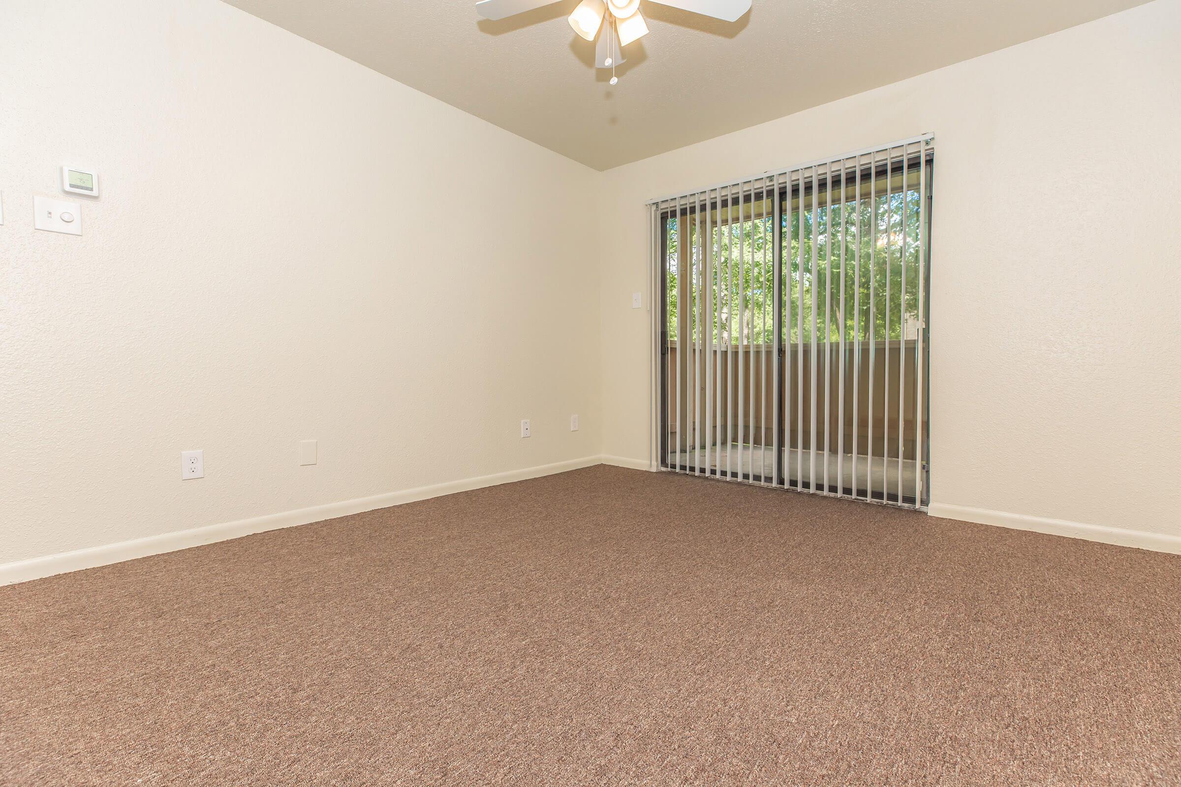 Carpeted living room with sliding glass doors