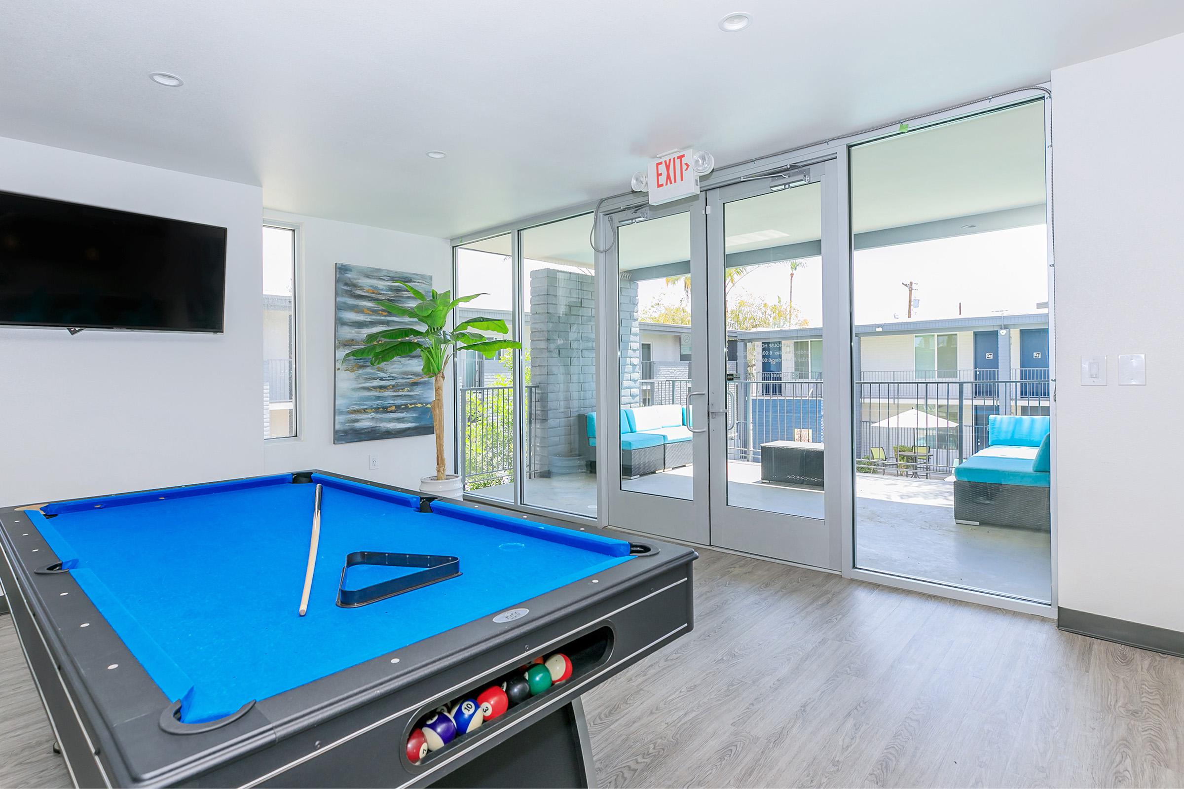 Rise Canyon West Indoor clubhouse area with a blue pool table and flat screen tv