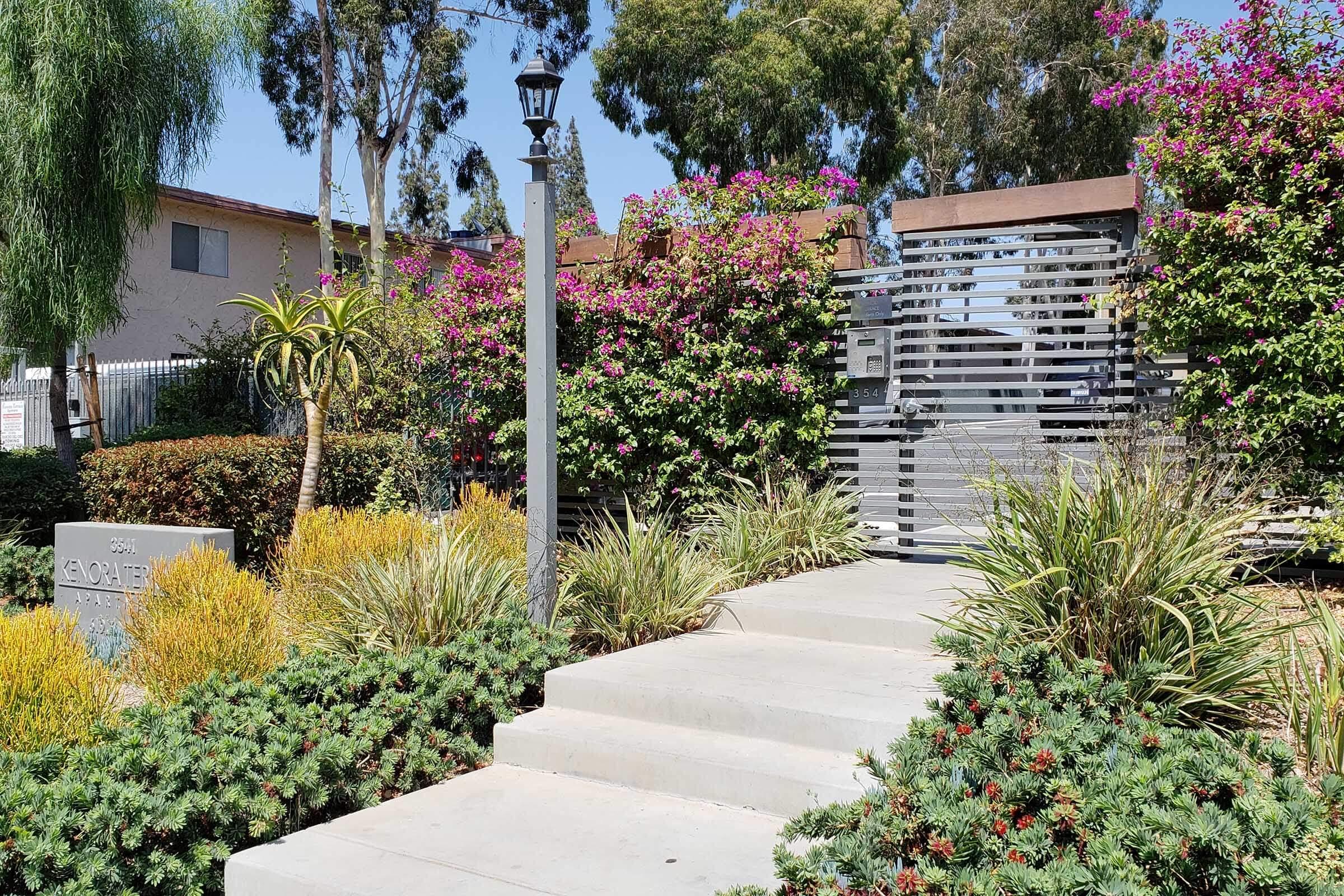 a close up of a flower garden in front of a house