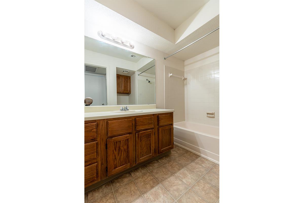 a kitchen with wooden cabinets