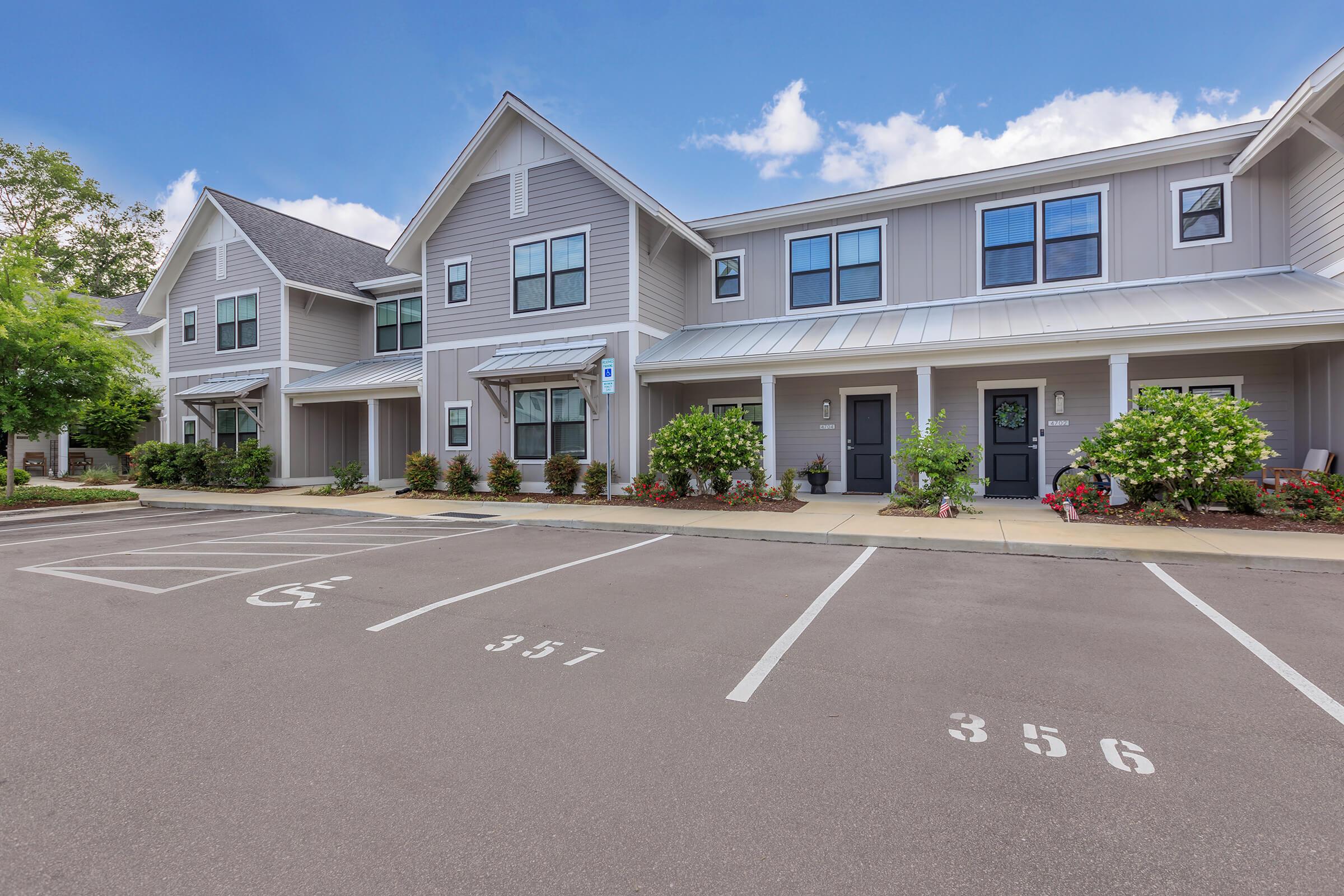 an empty parking lot in front of a house