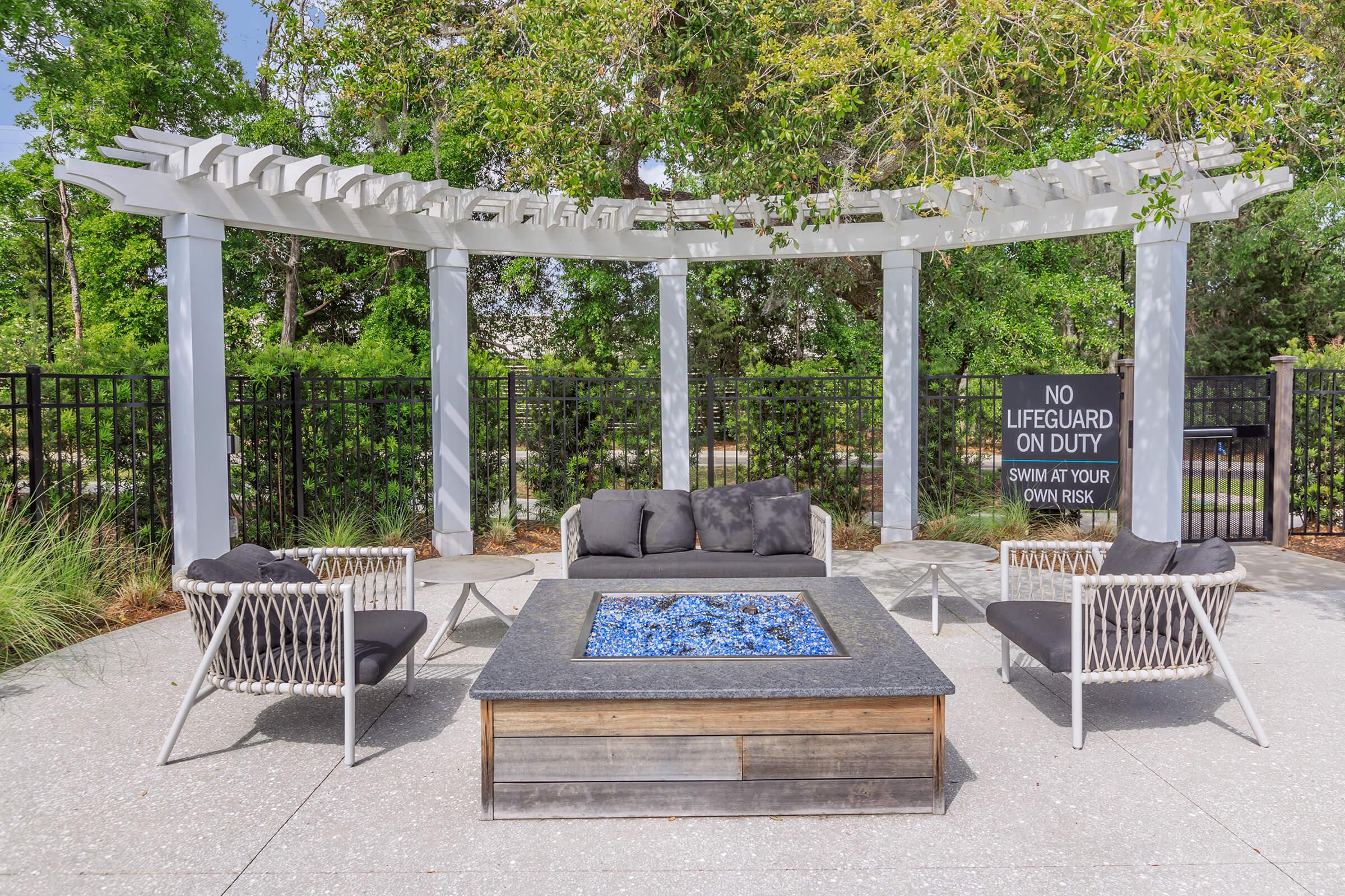 a statue of a cement bench sitting next to a fence