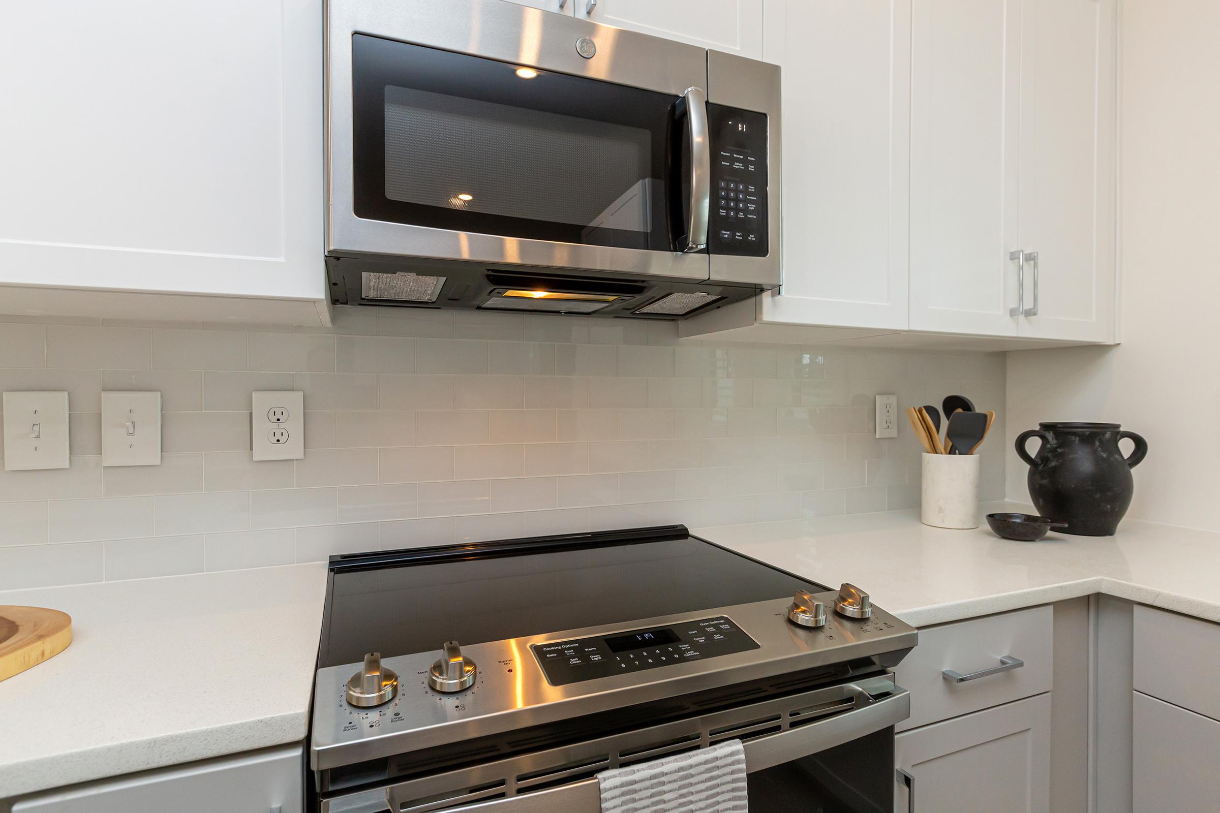 a microwave oven sitting on top of a stove