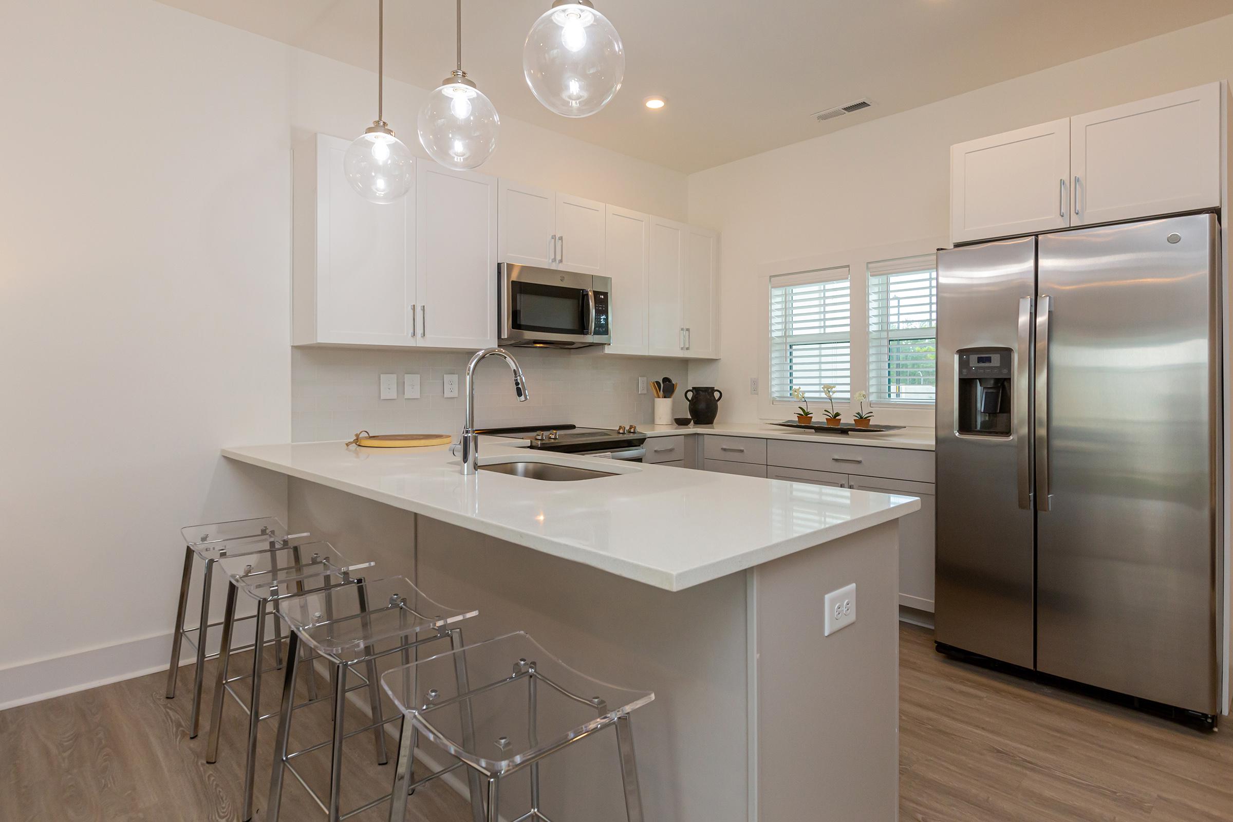 a large kitchen with stainless steel appliances