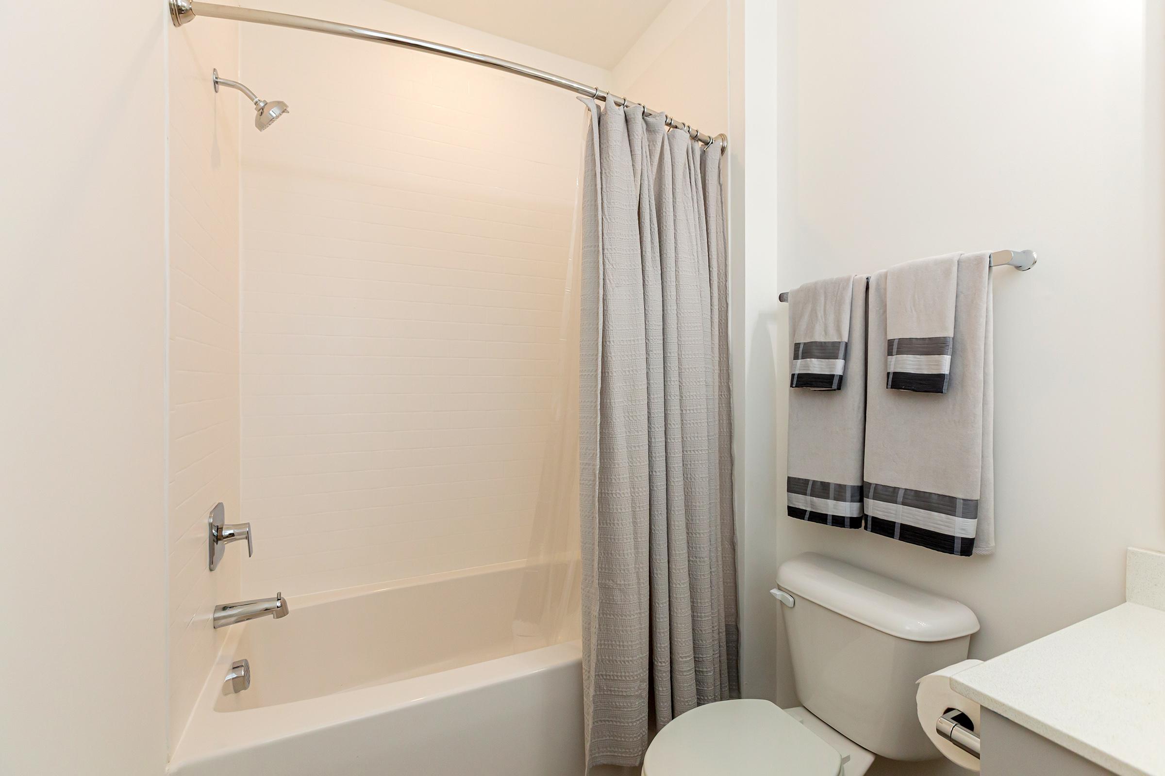 a shower curtain next to a sink