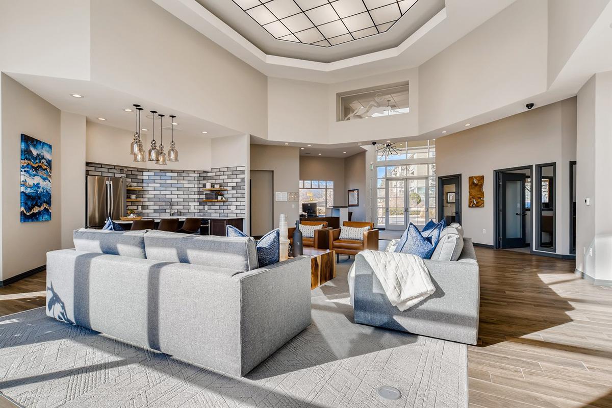 a living room filled with furniture and a large window