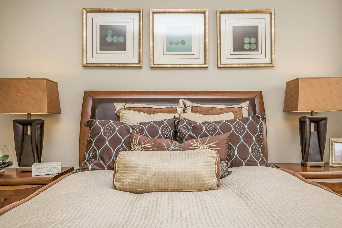a bedroom with a bed and desk in a room