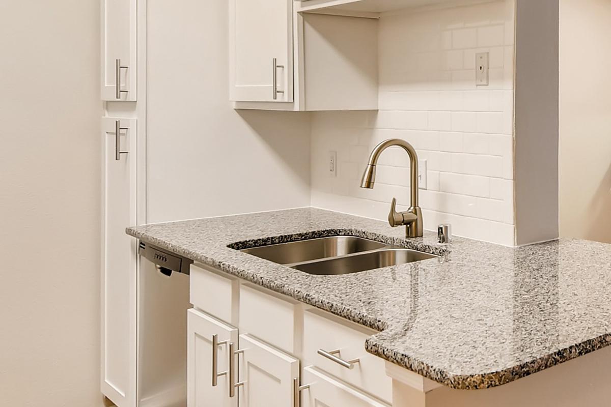 a kitchen with a sink and a mirror