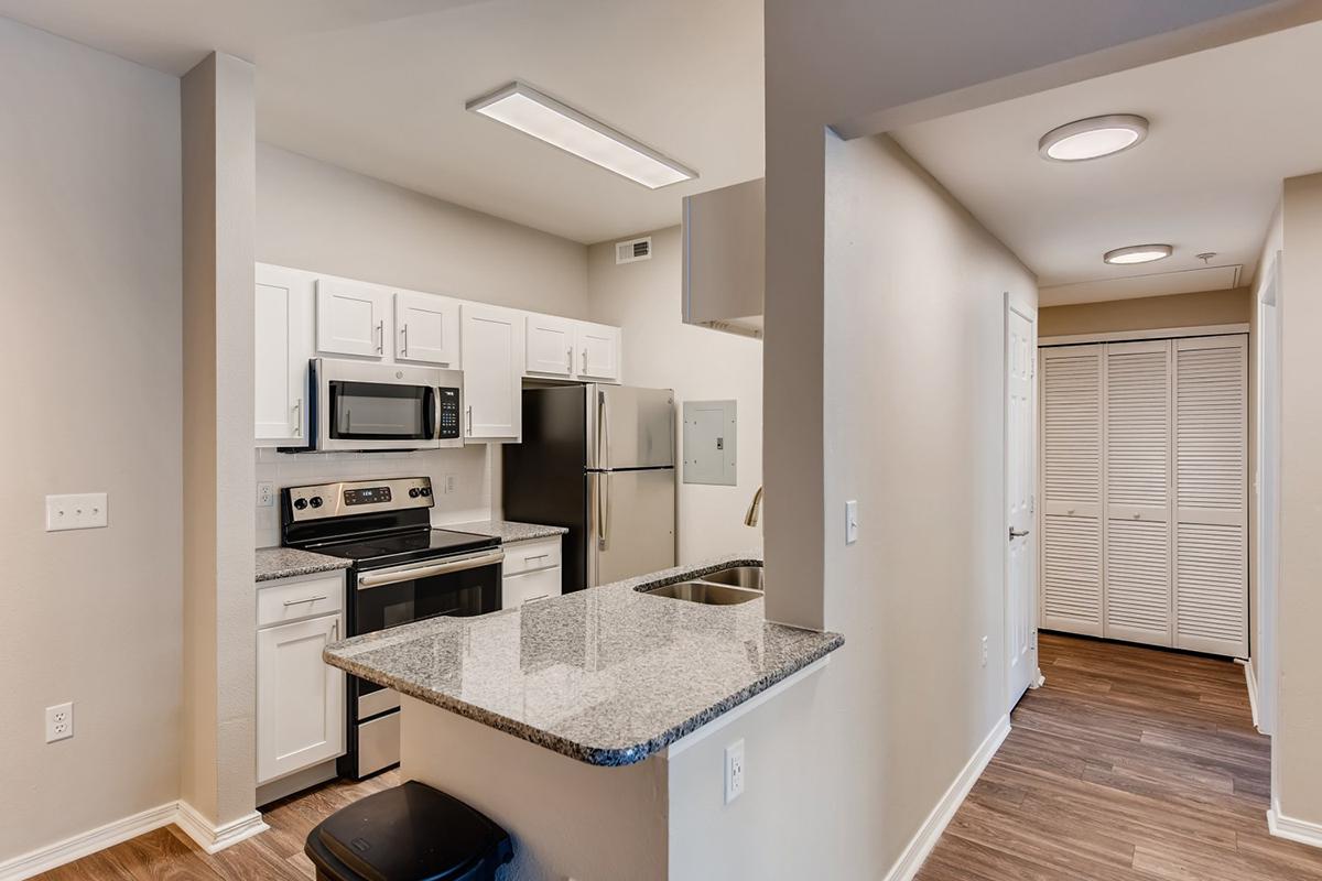 a kitchen with a sink and a mirror