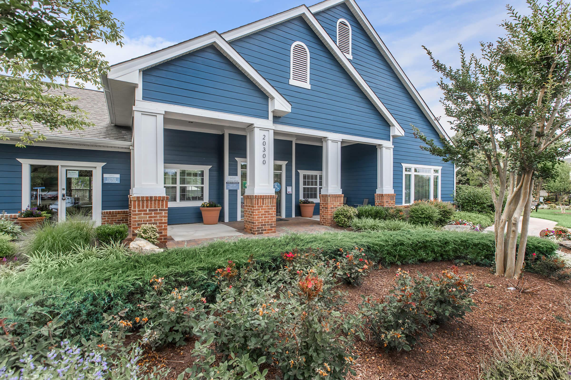 a house with bushes in front of a building