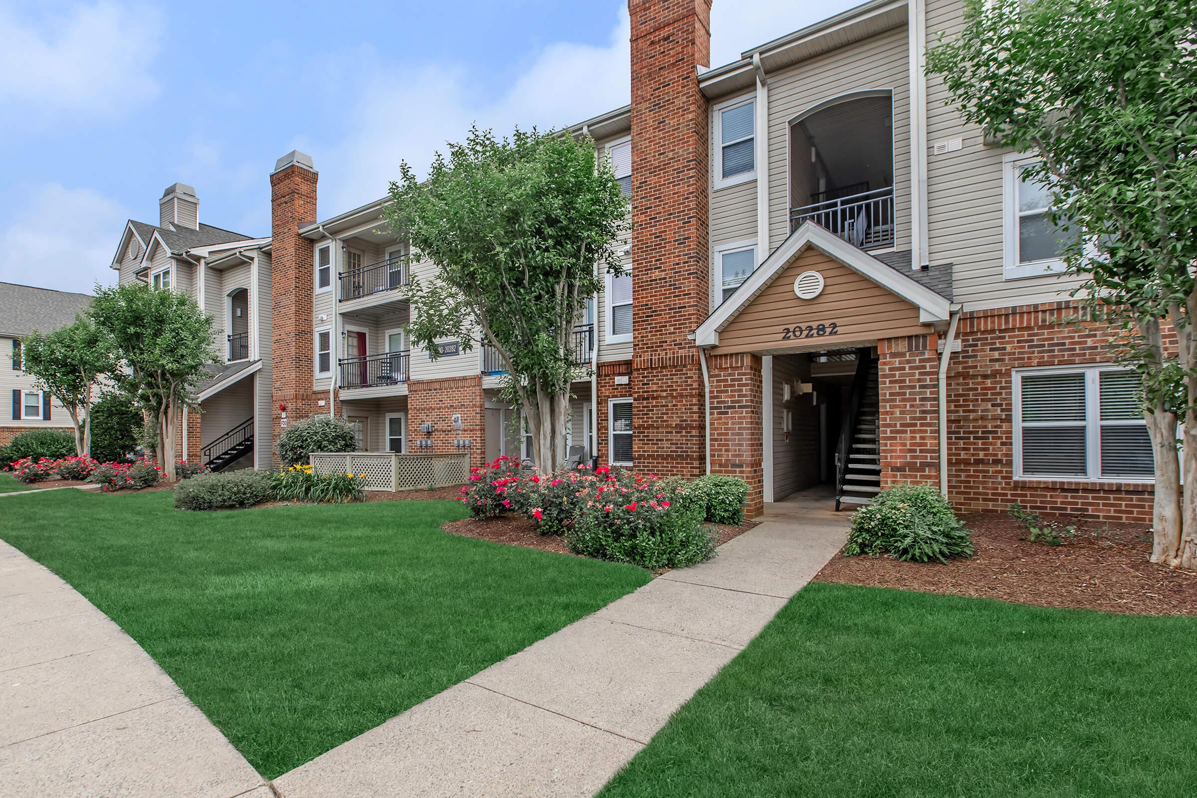 a large lawn in front of a brick building