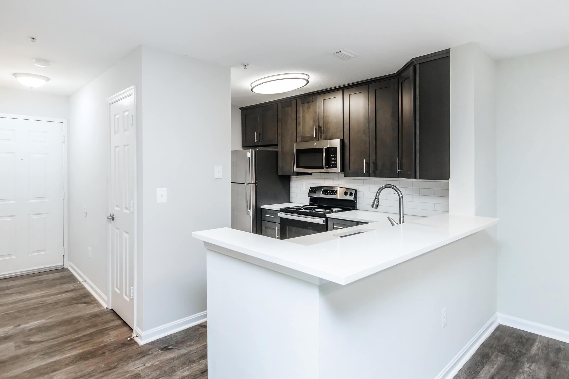 a kitchen with a sink and a mirror