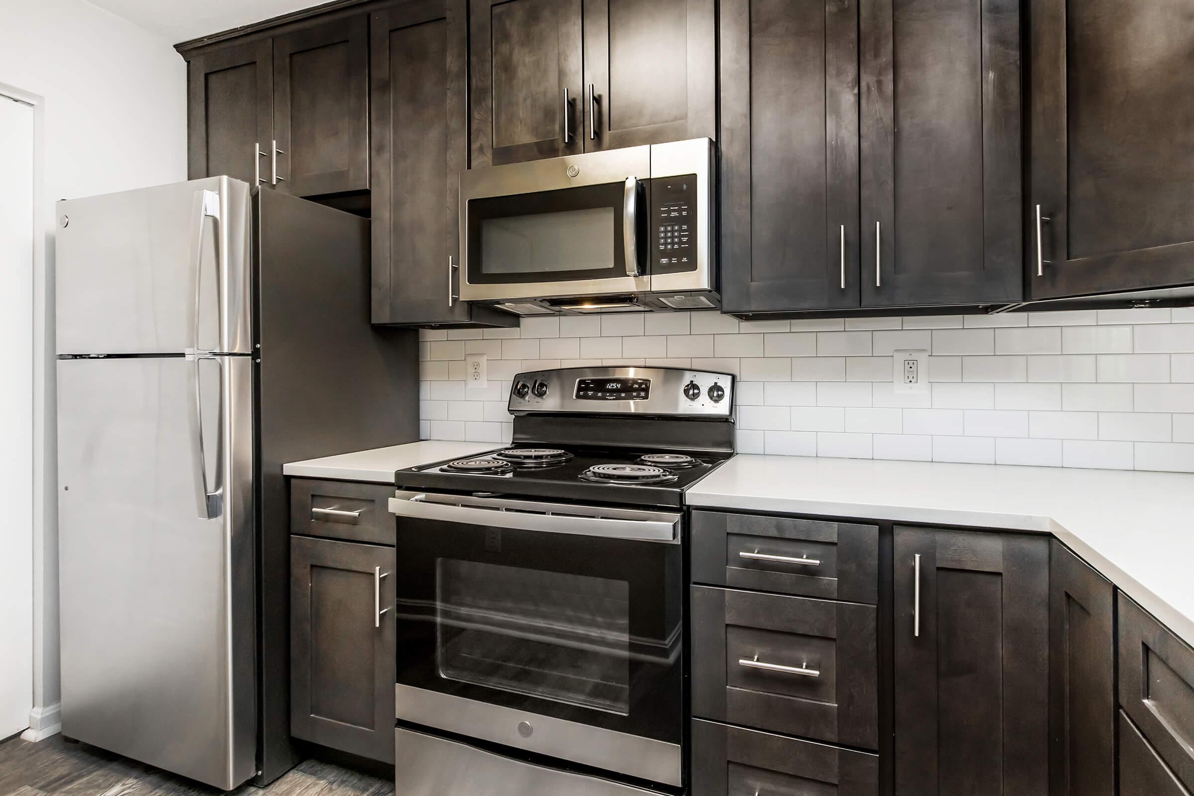 a kitchen with stainless steel appliances and wooden cabinets