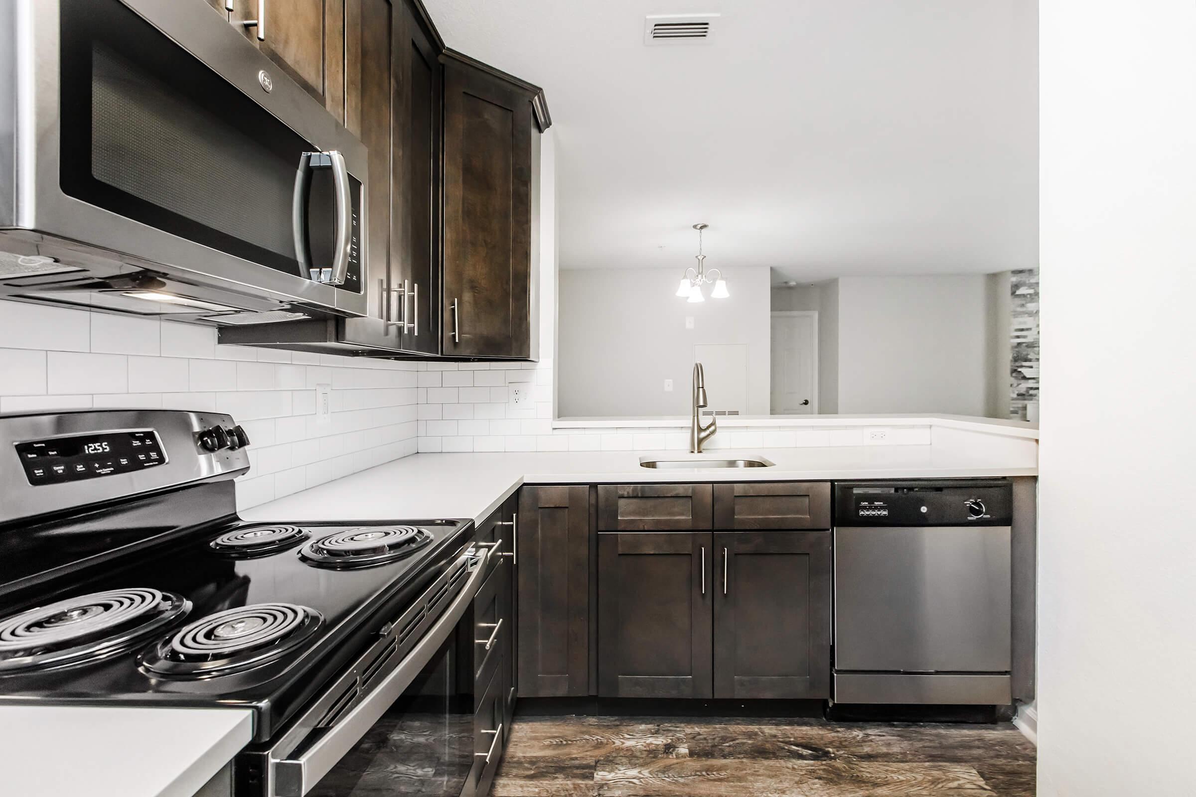 a stove top oven sitting inside of a kitchen