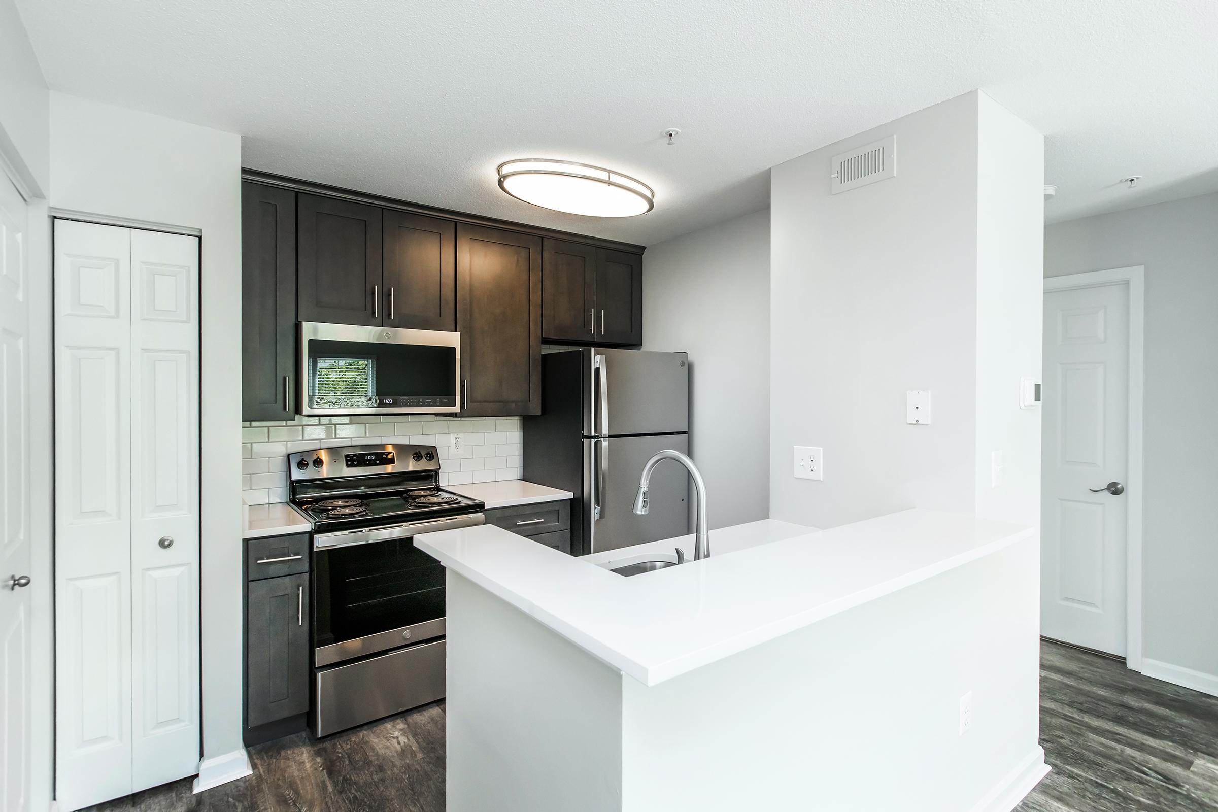 a kitchen with a sink and a refrigerator