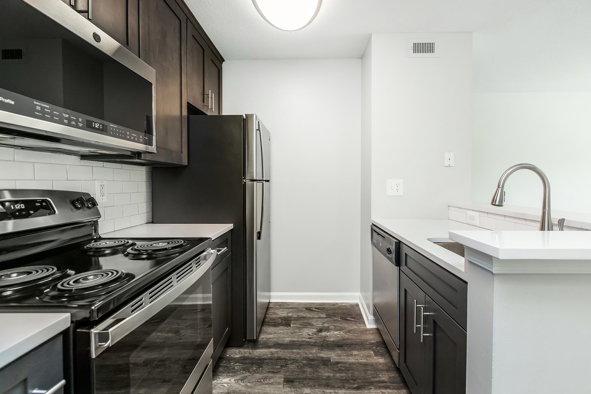 a stove top oven sitting inside of a kitchen