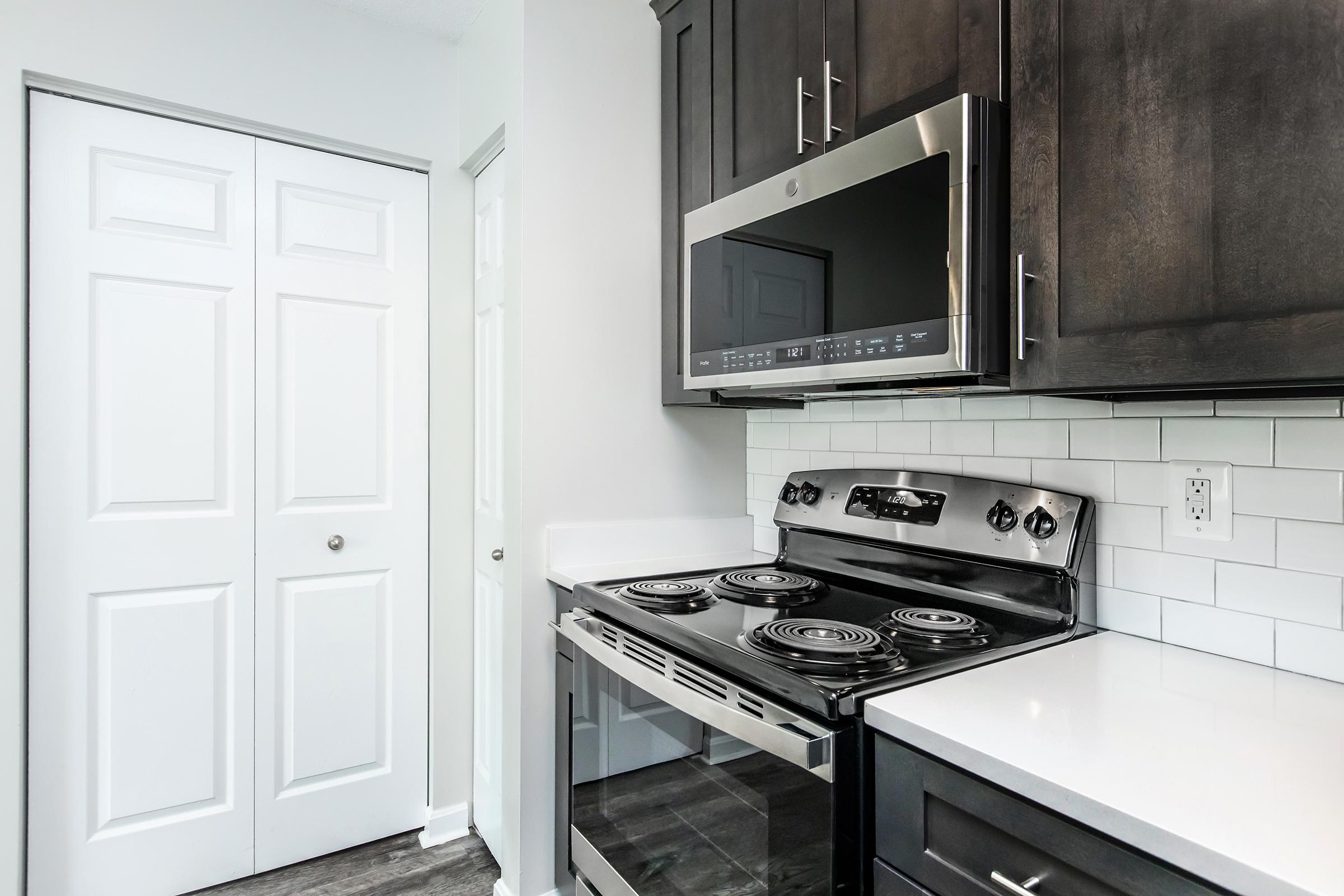 a stove top oven sitting inside of a kitchen