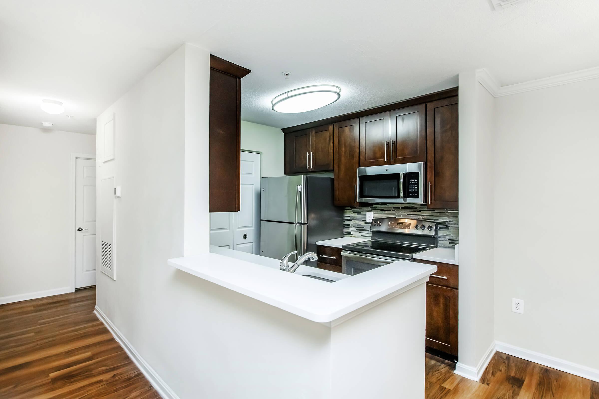 a kitchen with a sink and a mirror