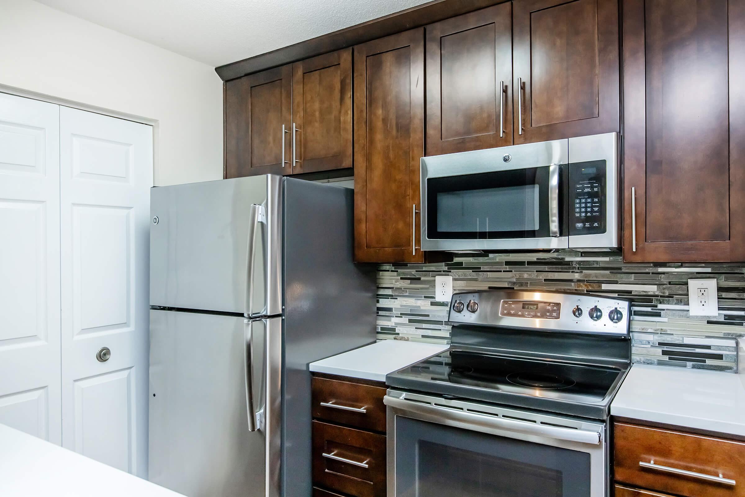 a stove top oven sitting inside of a kitchen