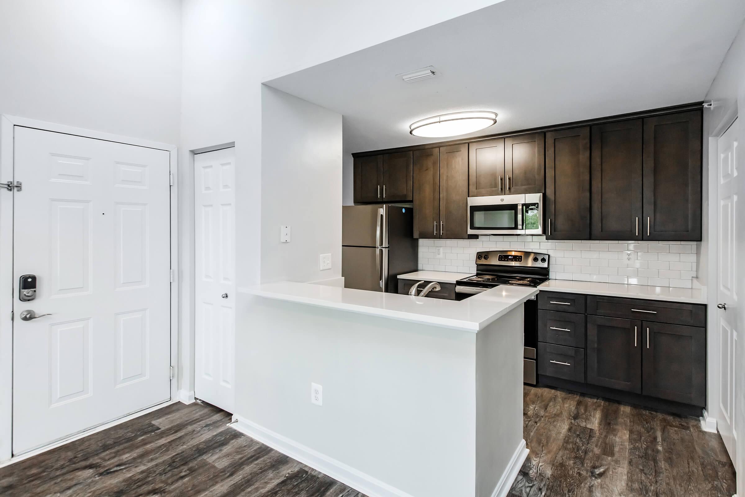 a kitchen with a sink and a refrigerator