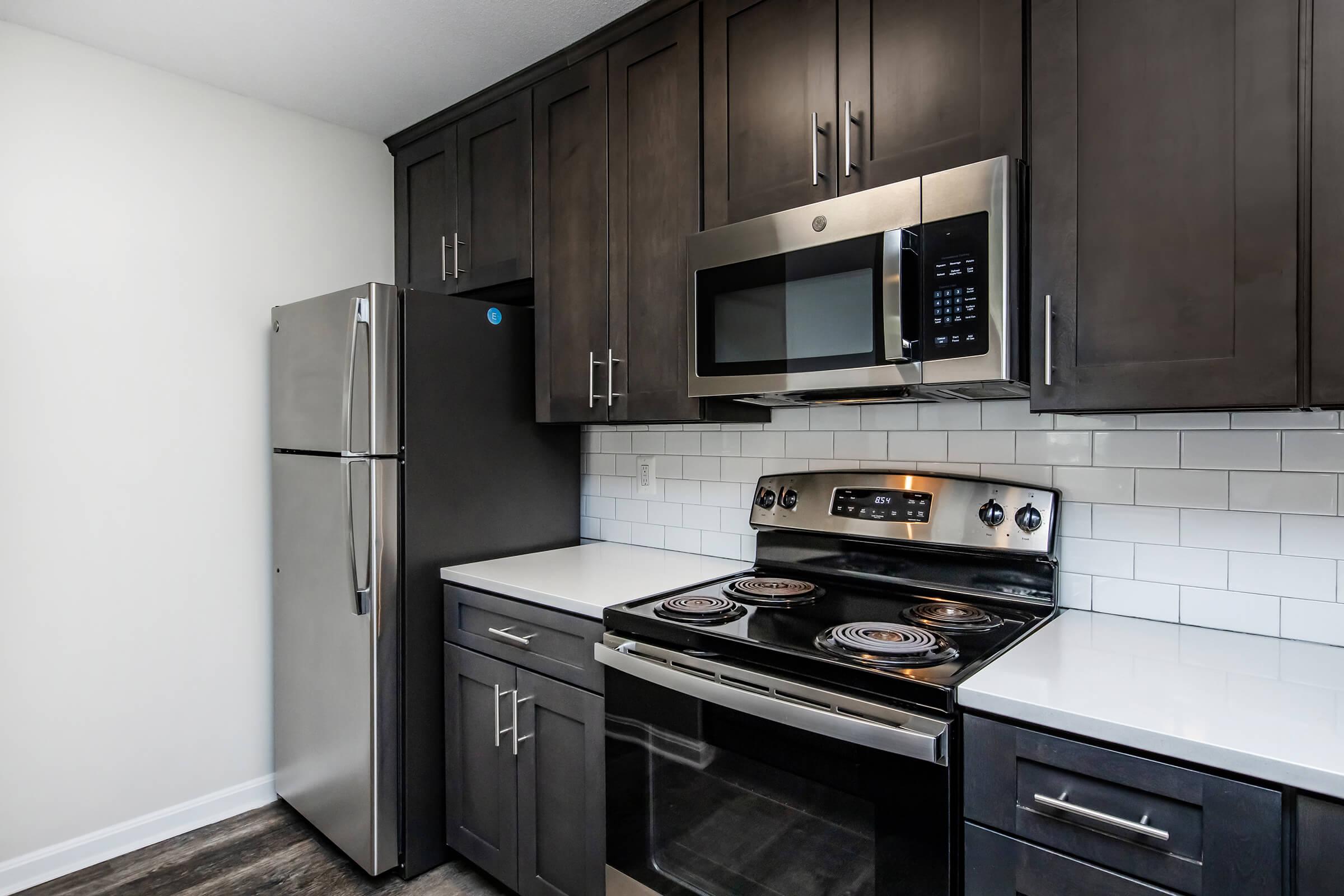 a stove top oven sitting inside of a kitchen